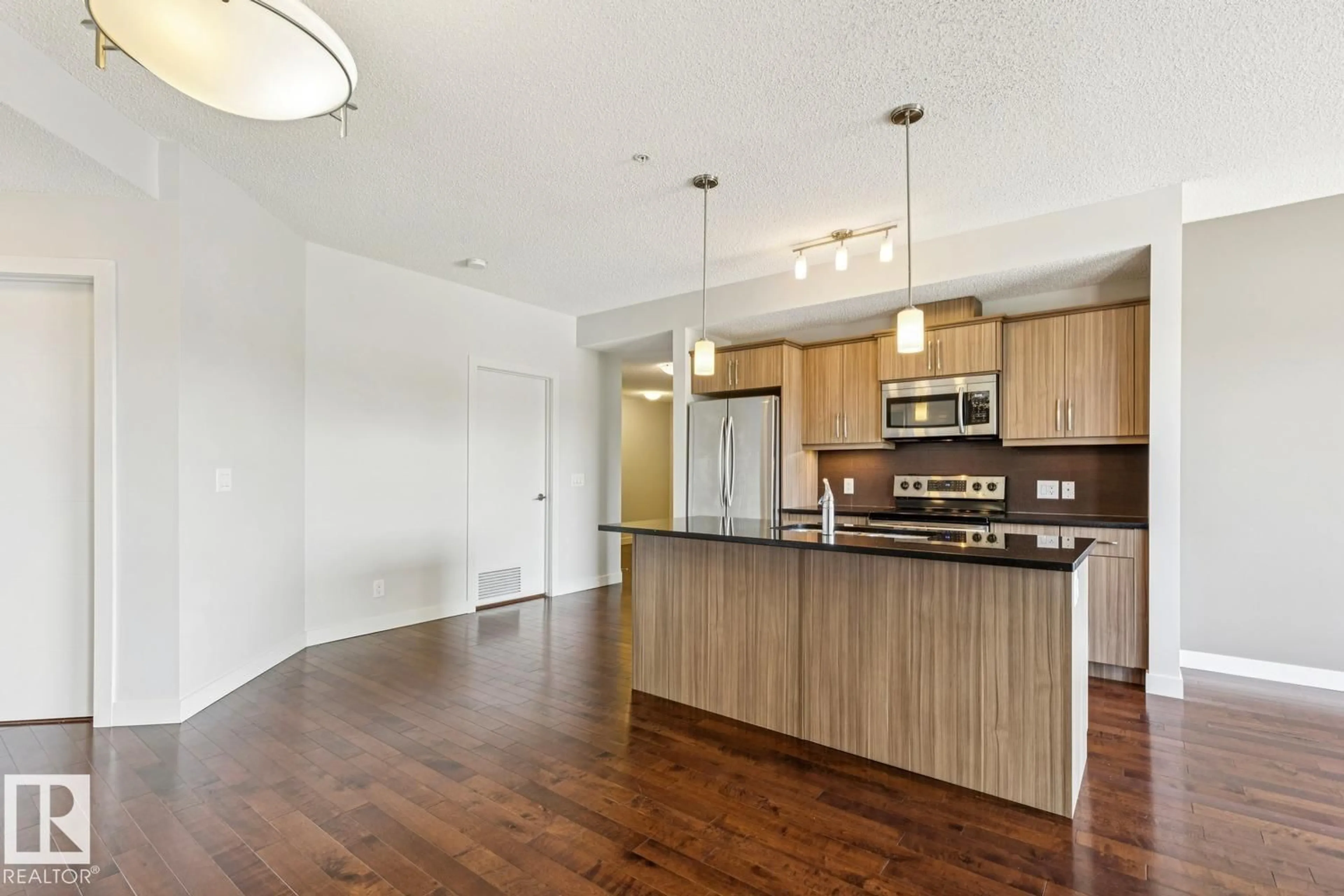 Open concept kitchen, wood/laminate floor for #217 - 10523 123 ST, Edmonton Alberta T5N1N9