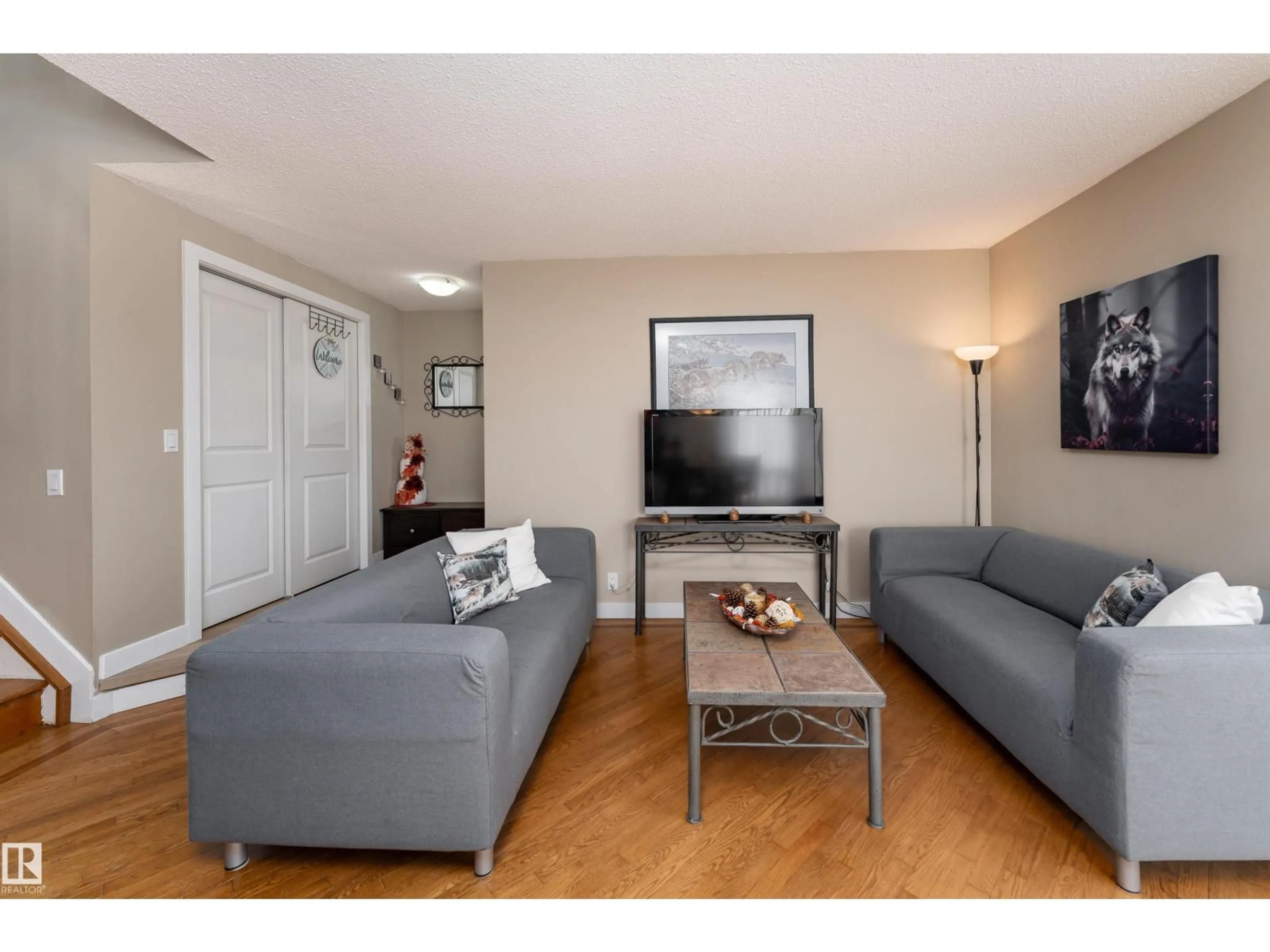 Living room with furniture, wood/laminate floor for 6007 37 AV, Edmonton Alberta T6L1V3