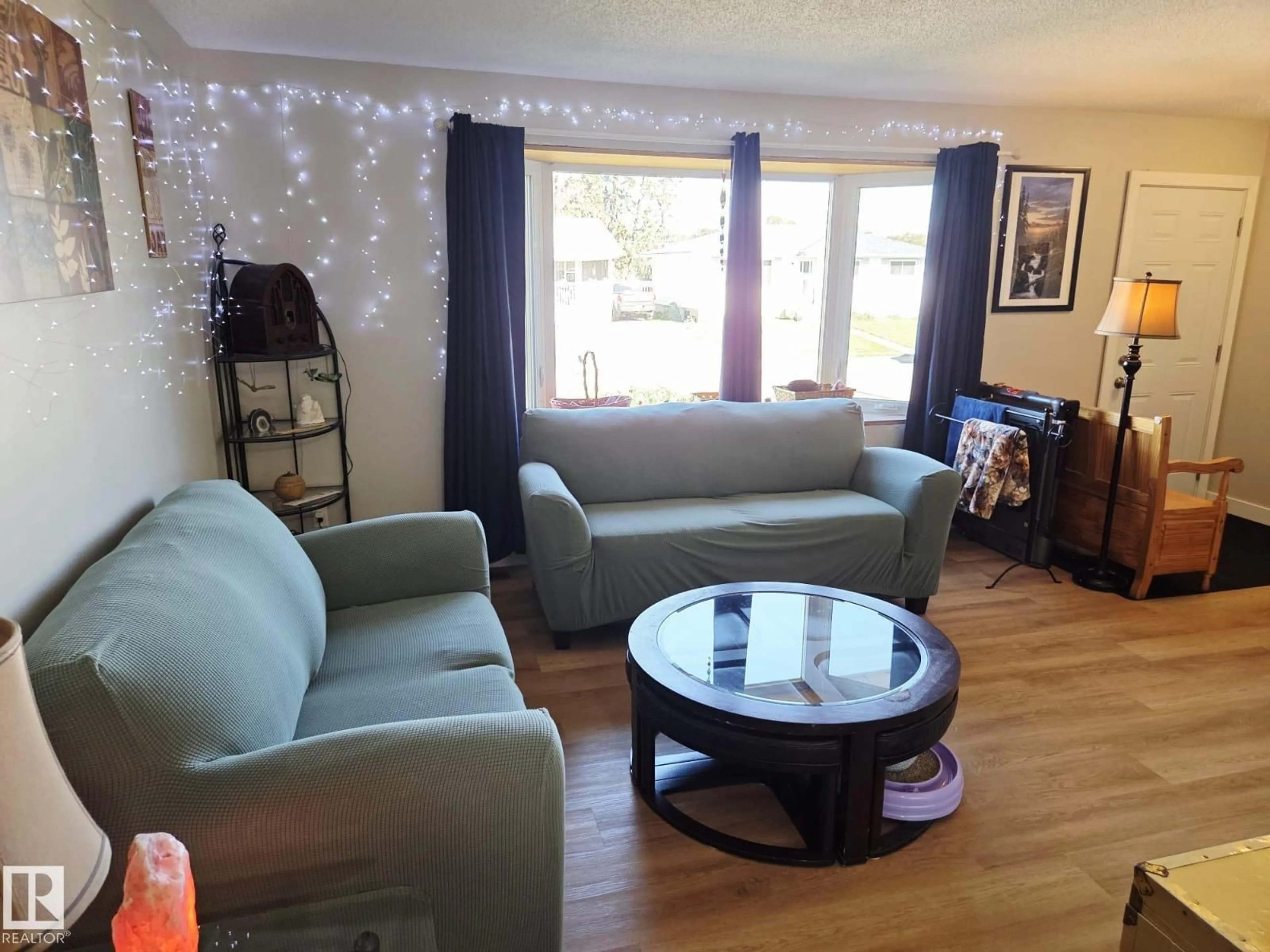 Living room with furniture, wood/laminate floor for 5807 51 AV, Redwater Alberta T0A2W0