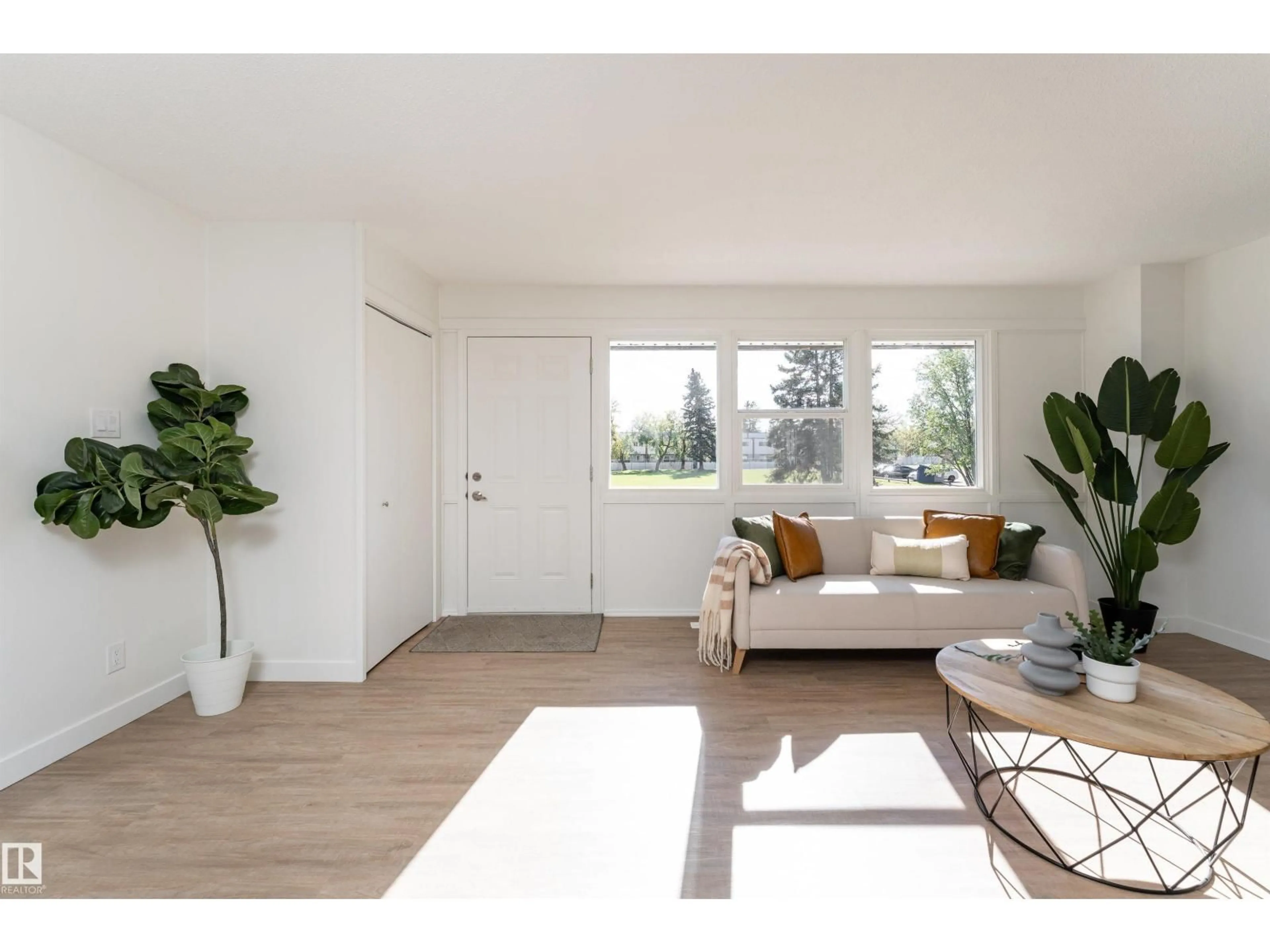 Living room with furniture, wood/laminate floor for 113 VILLAGE ON THE GREEN GR, Edmonton Alberta T5A1H2