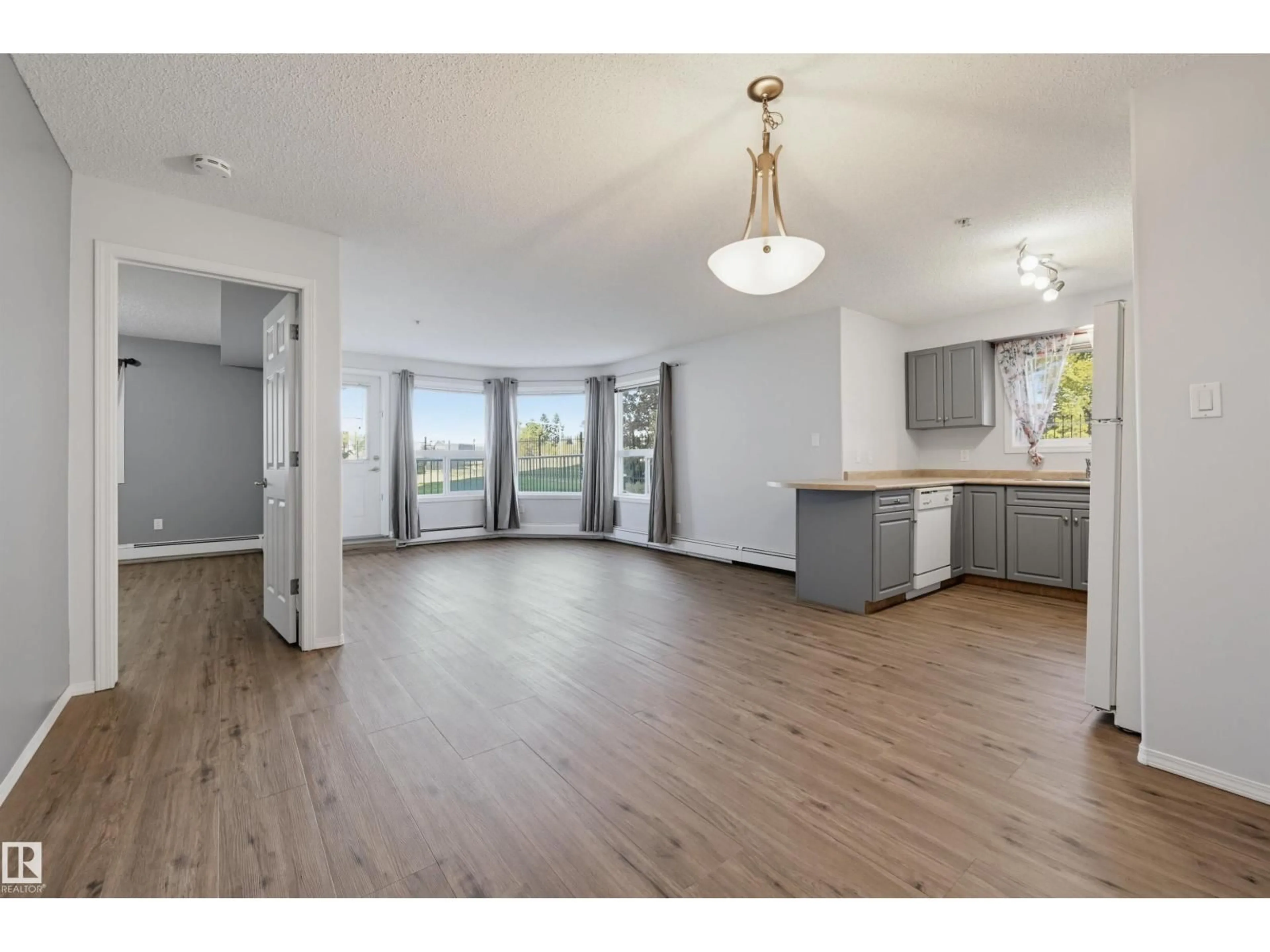 Open concept kitchen, wood/laminate floor for #107 - 13635 34 ST, Edmonton Alberta T5A0C4
