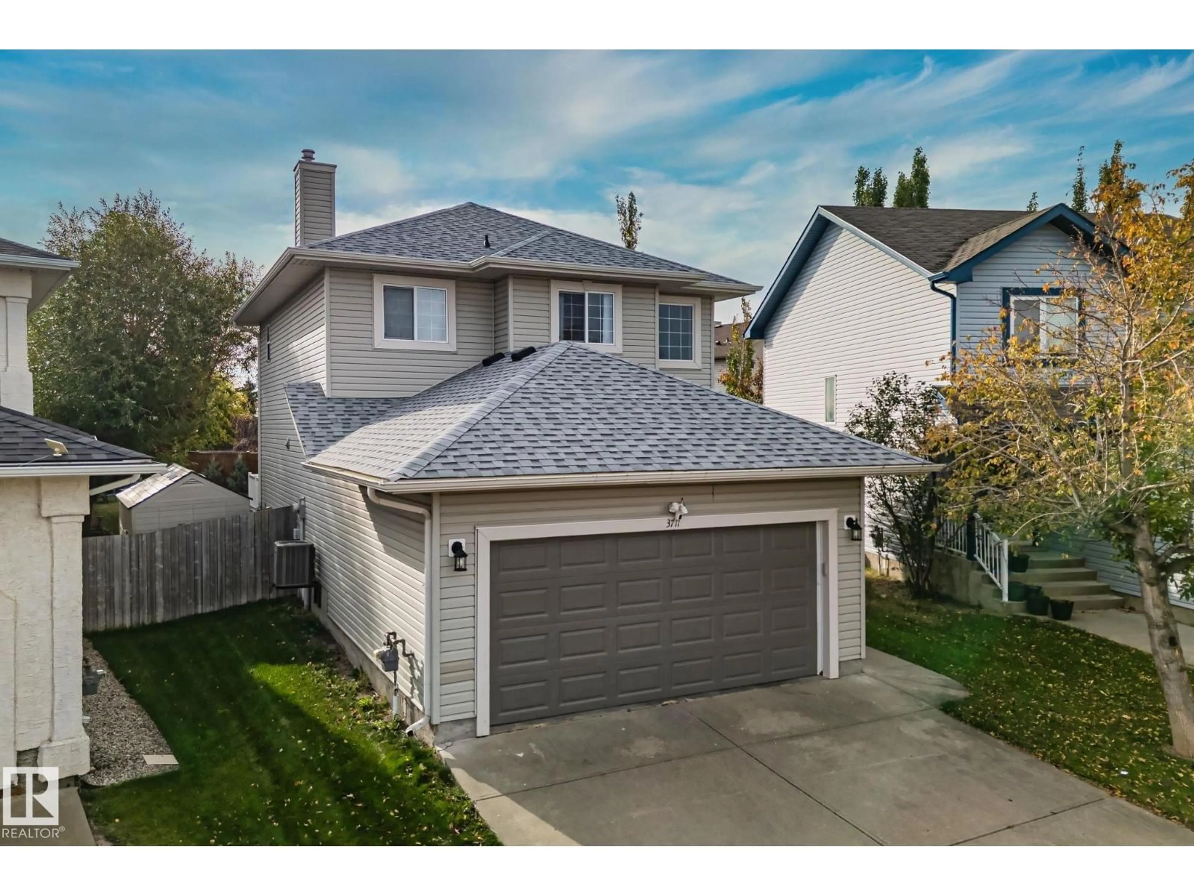 Home with vinyl exterior material, street for NW - 3711 161 AV, Edmonton Alberta T5Y3G2