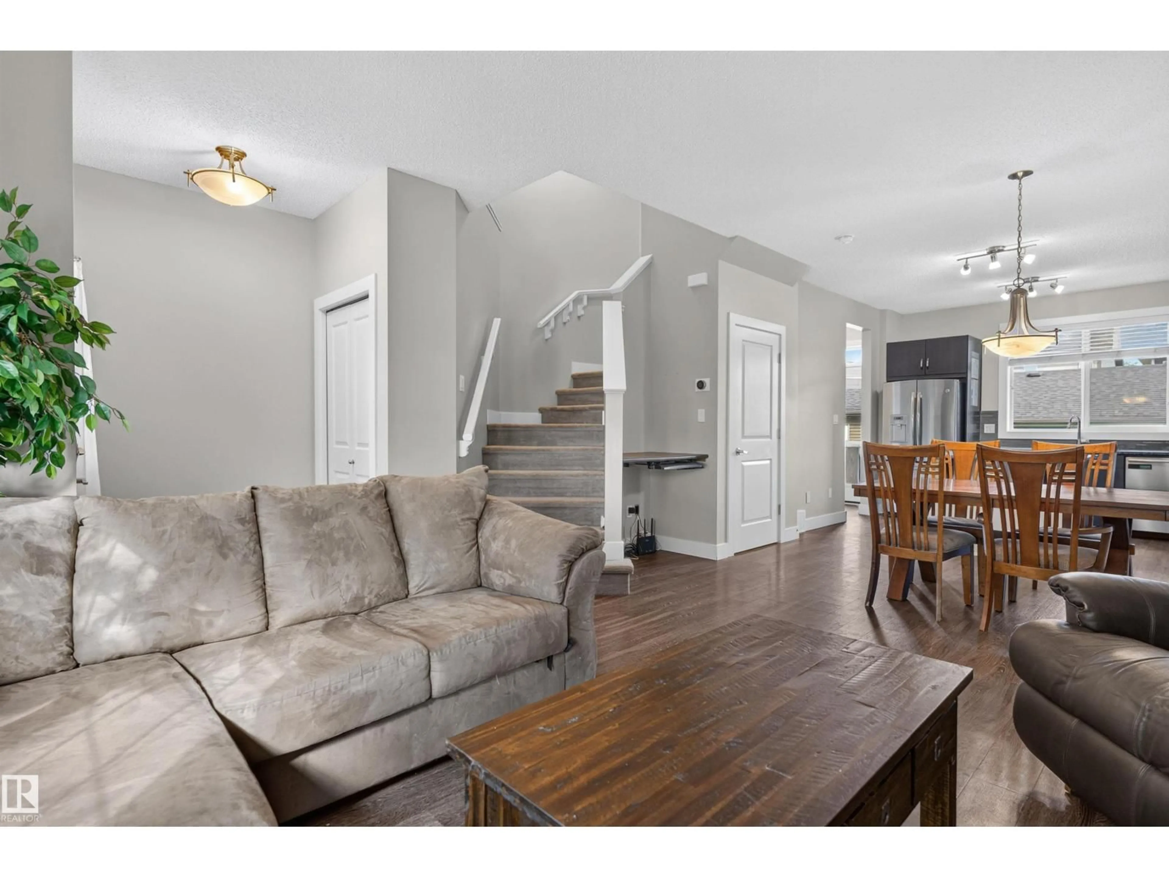Living room with furniture, wood/laminate floor for LI NW - 9082 ROSENTHAL LINK, Edmonton Alberta T5T7A6