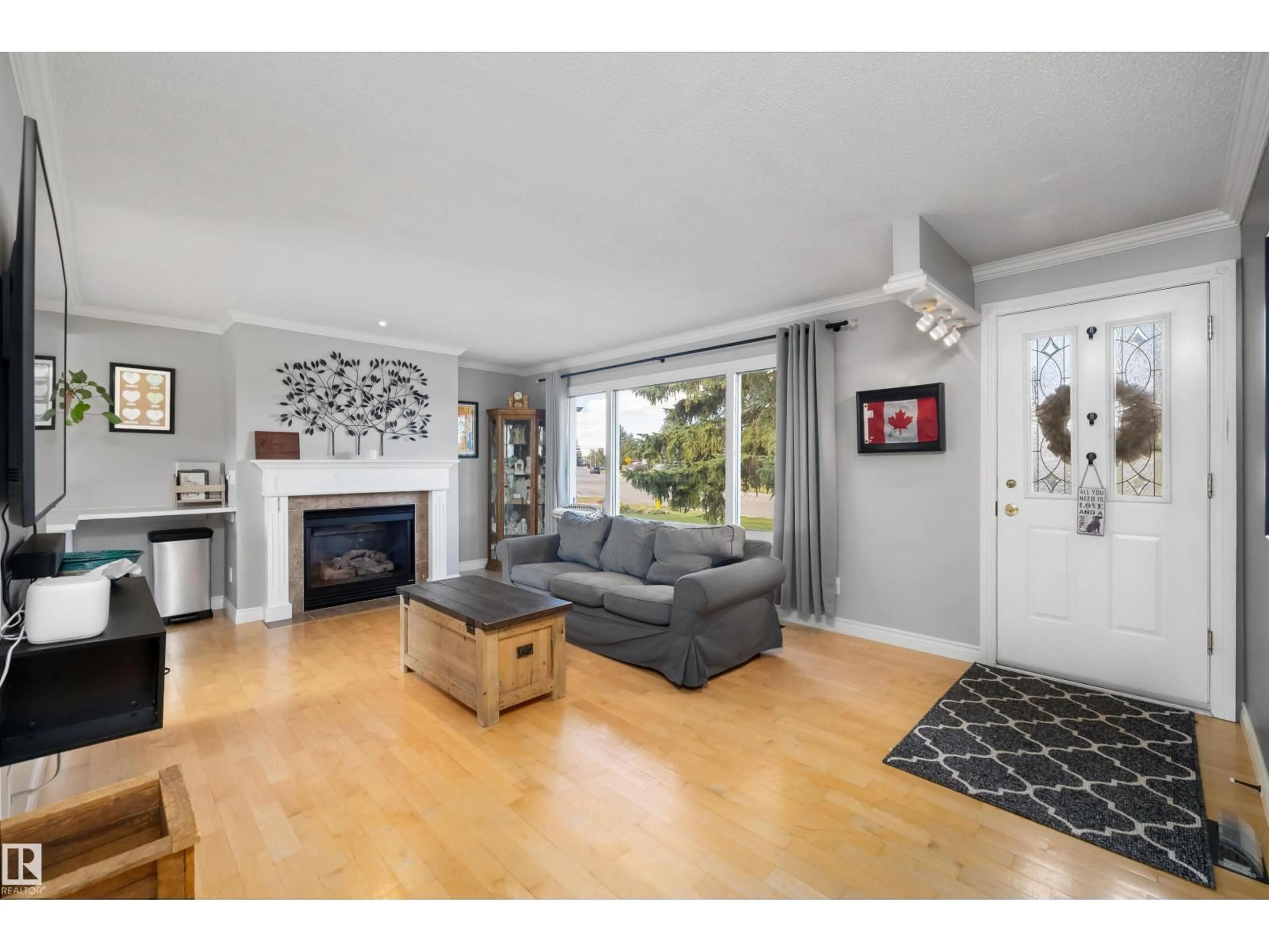 Living room with furniture, wood/laminate floor for 7807 134 AV, Edmonton Alberta T5C2G2