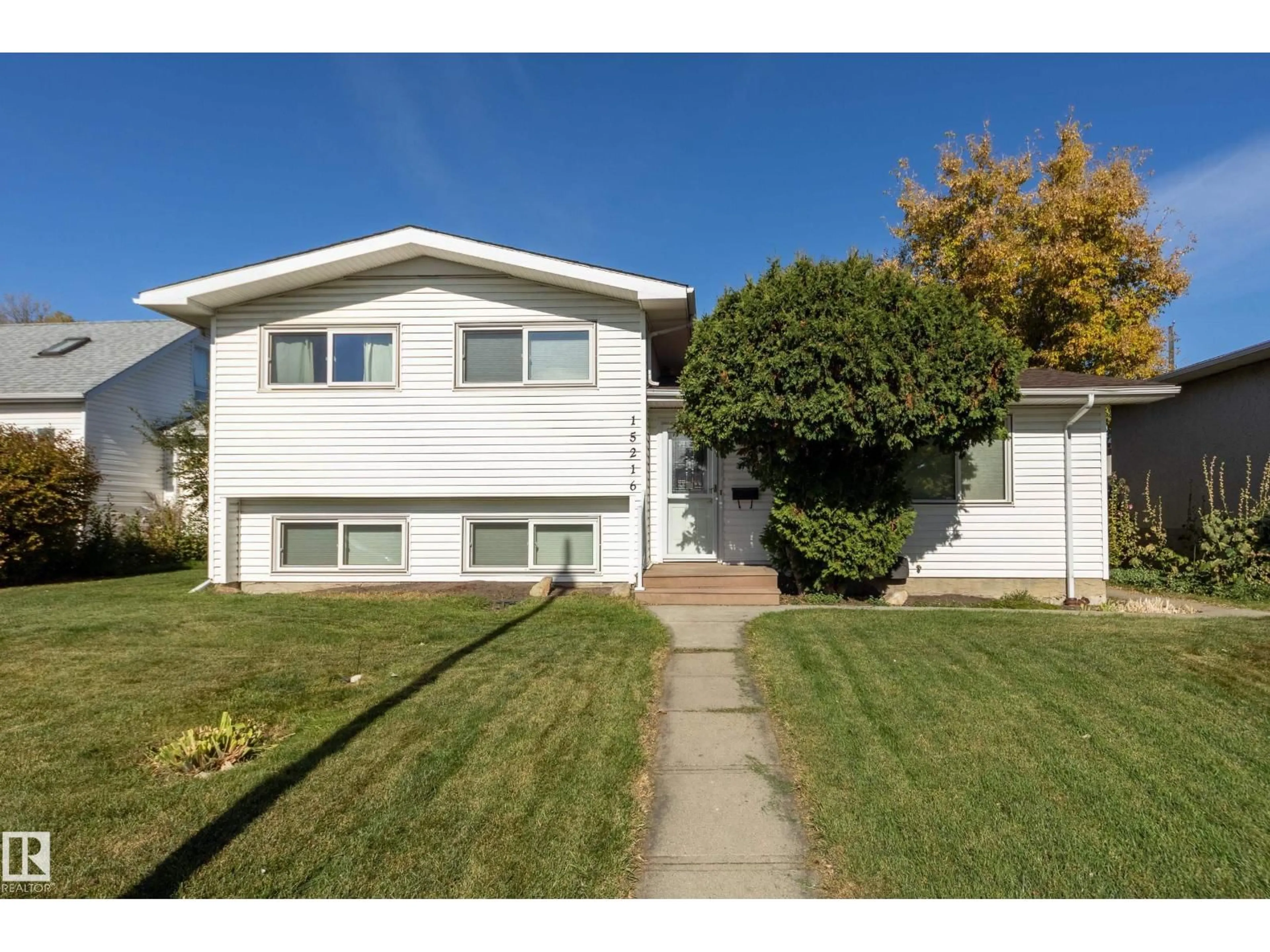 Home with vinyl exterior material, street for 15216 86 AV NW, Edmonton Alberta T5R4C3