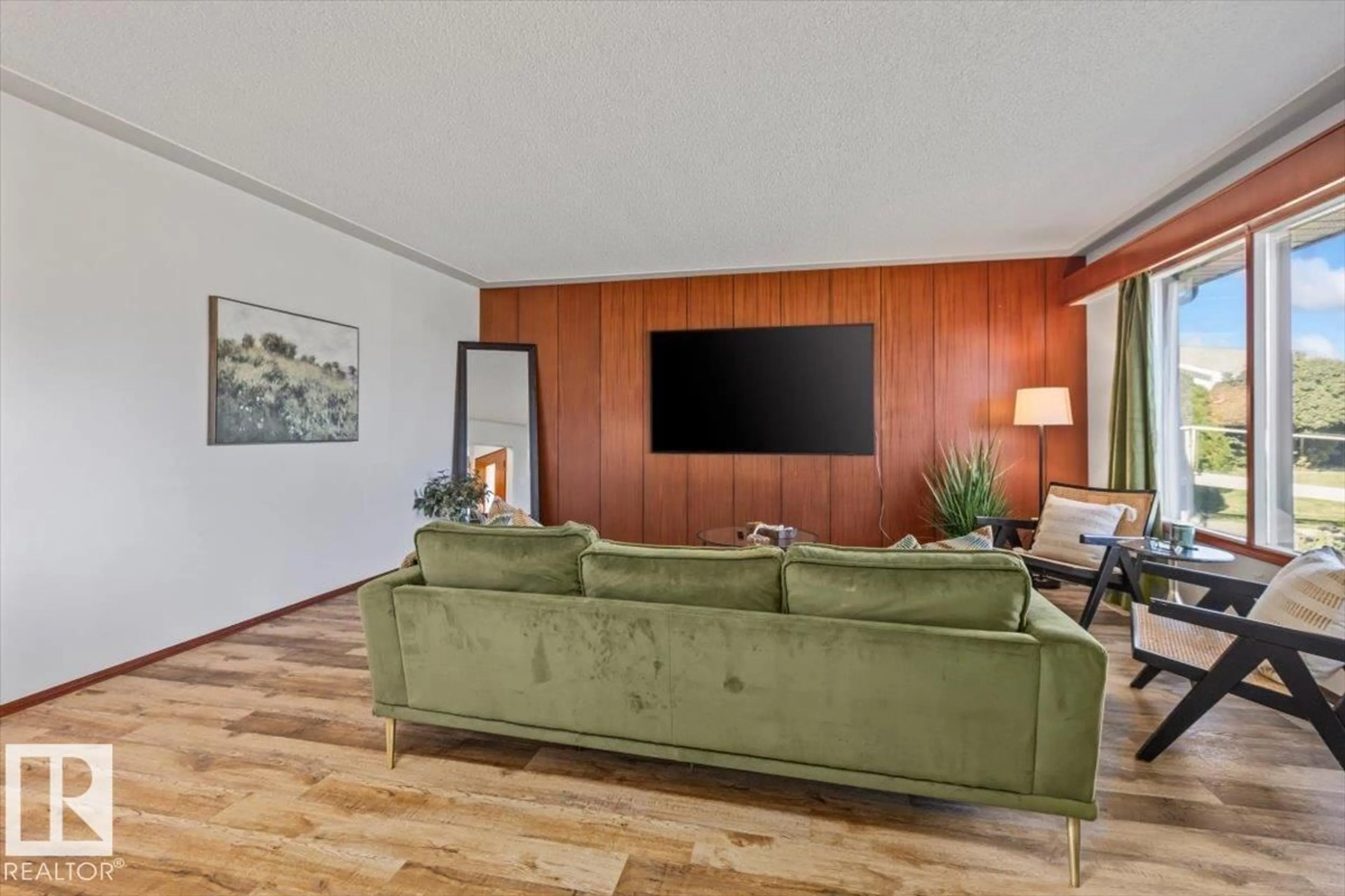 Living room with furniture, wood/laminate floor for 7627 128A AV, Edmonton Alberta T5C1V1