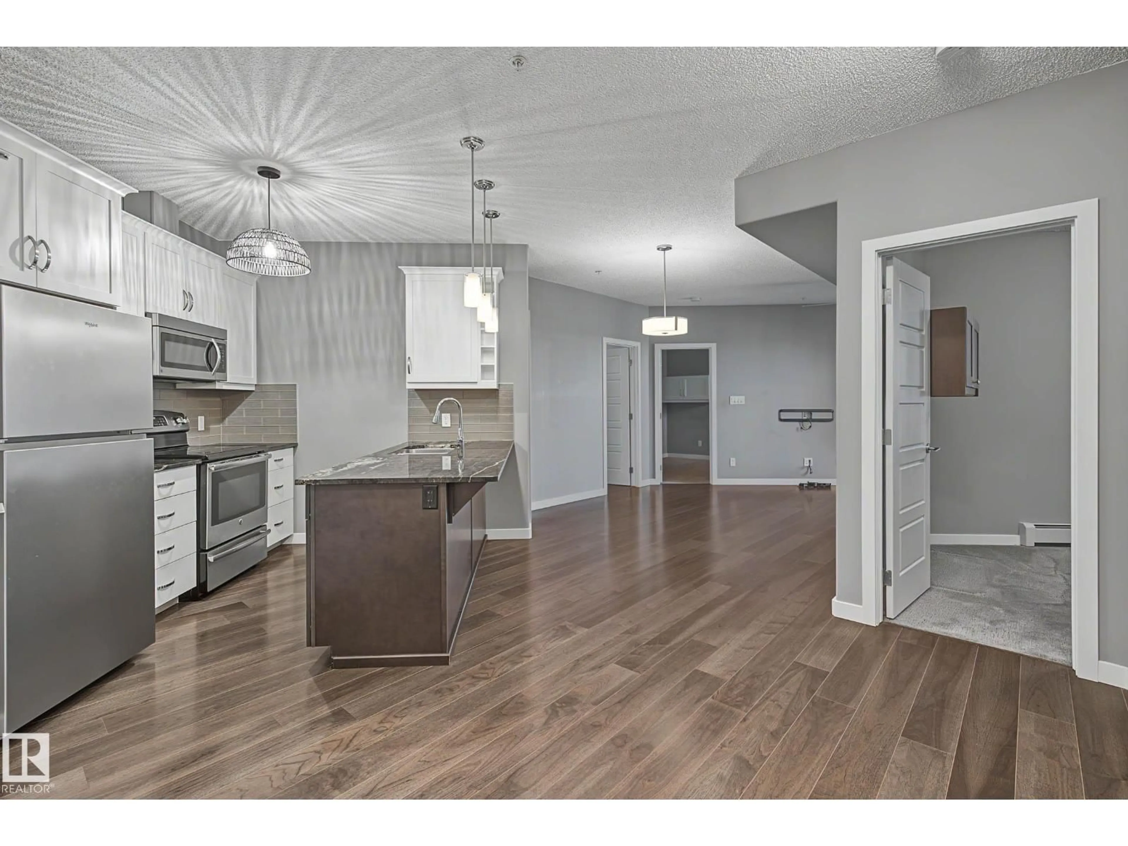 Open concept kitchen, wood/laminate floor for 1004 - 410 ROSENTHAL BV, Edmonton Alberta T5T7C6
