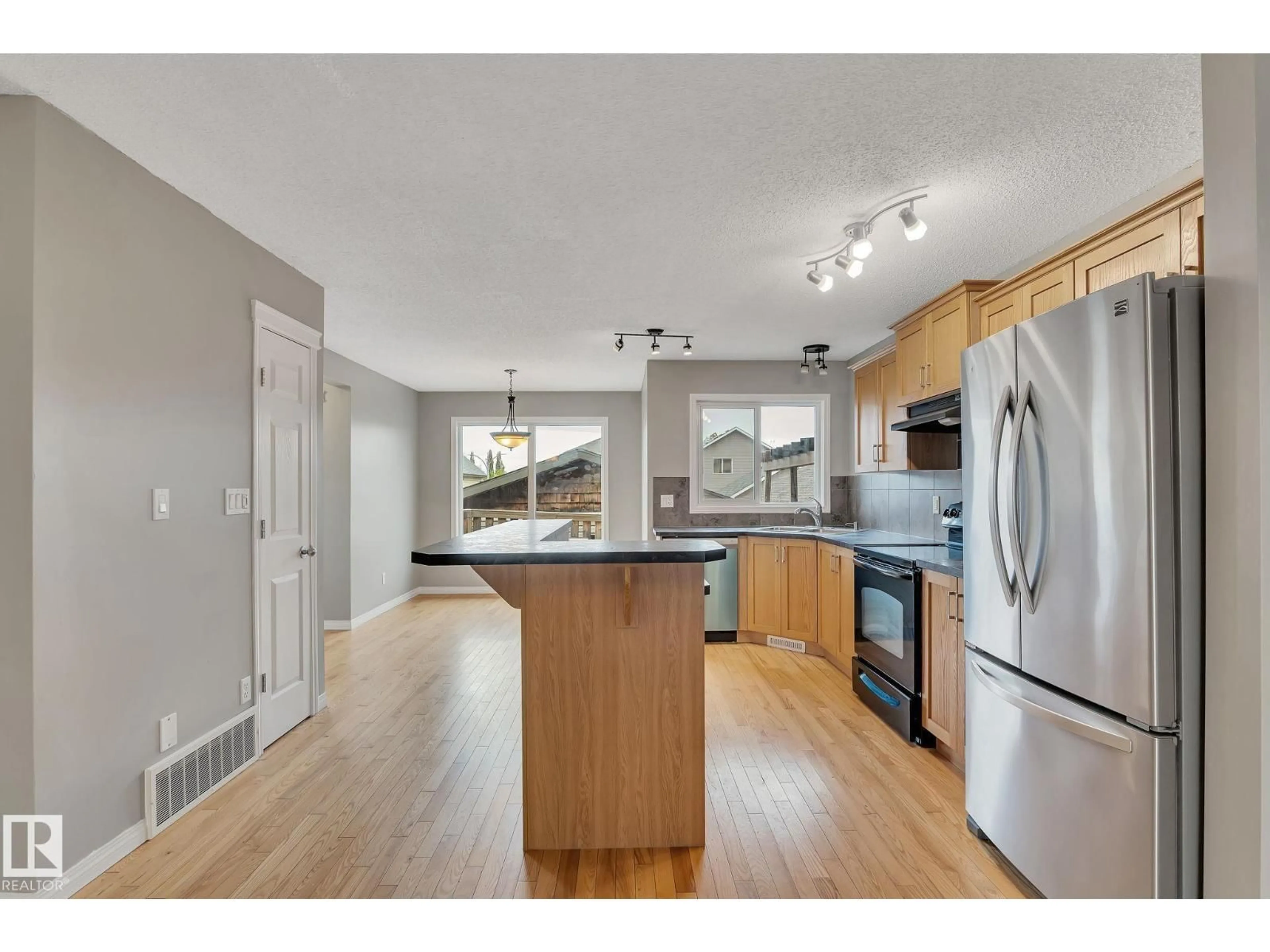 Open concept kitchen, wood/laminate floor for NW - 14771 141 ST, Edmonton Alberta T6V0A7