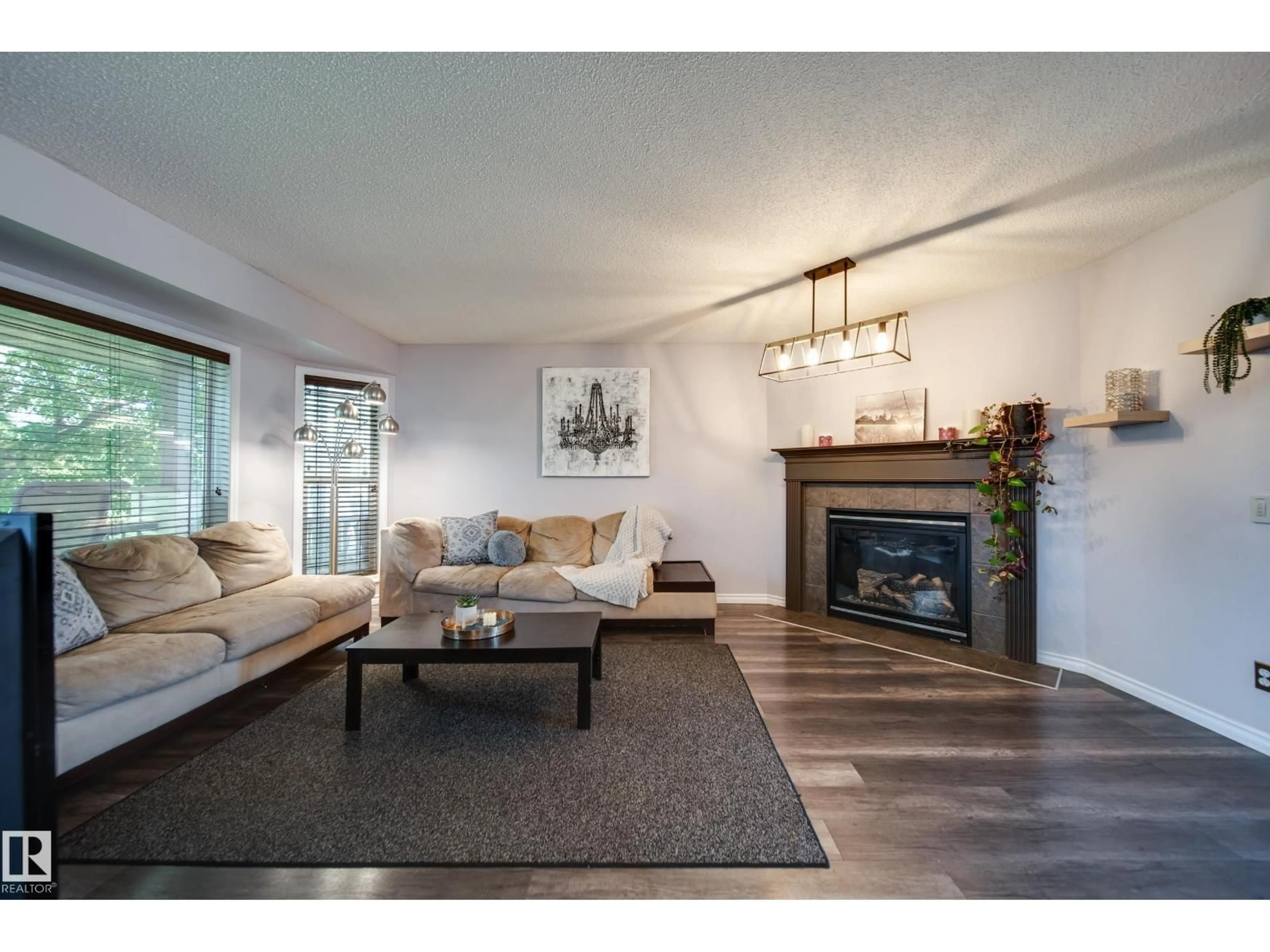 Living room with furniture, wood/laminate floor for 14006 158A AV, Edmonton Alberta T6V1V7