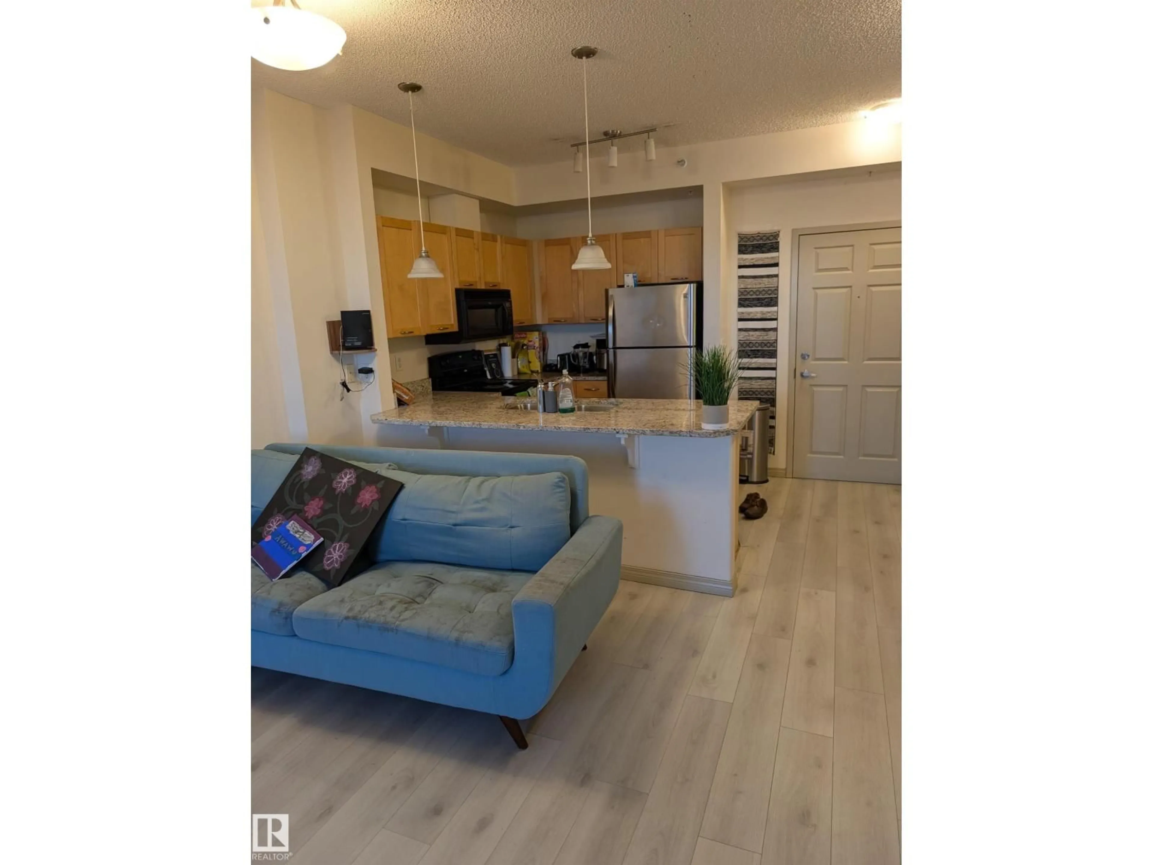 Open concept kitchen, wood/laminate floor for 1-504 - 4245 139 AV, Edmonton Alberta T5Y3E8