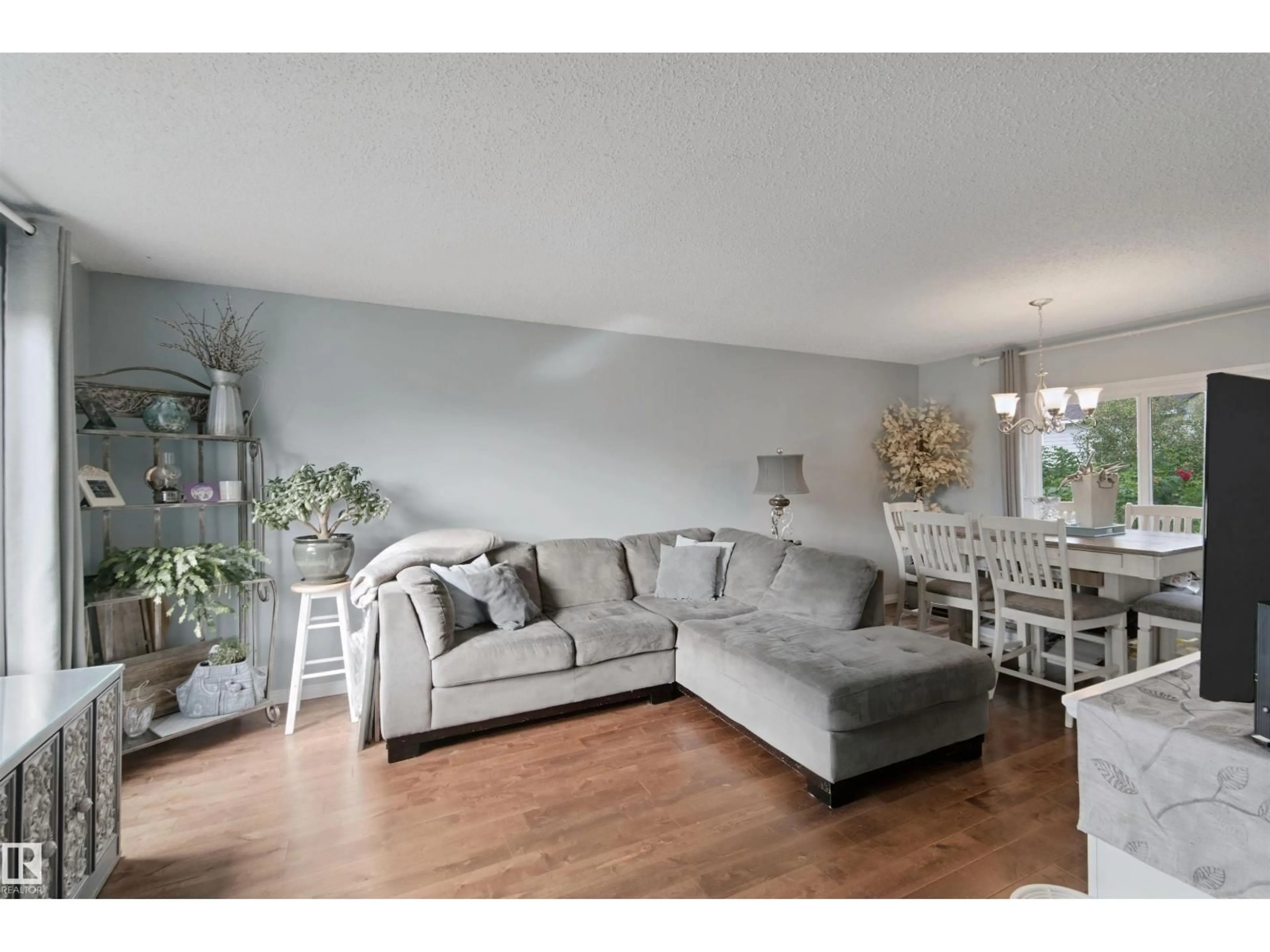 Living room with furniture, wood/laminate floor for 4528 35 AV, Edmonton Alberta T6L3P9