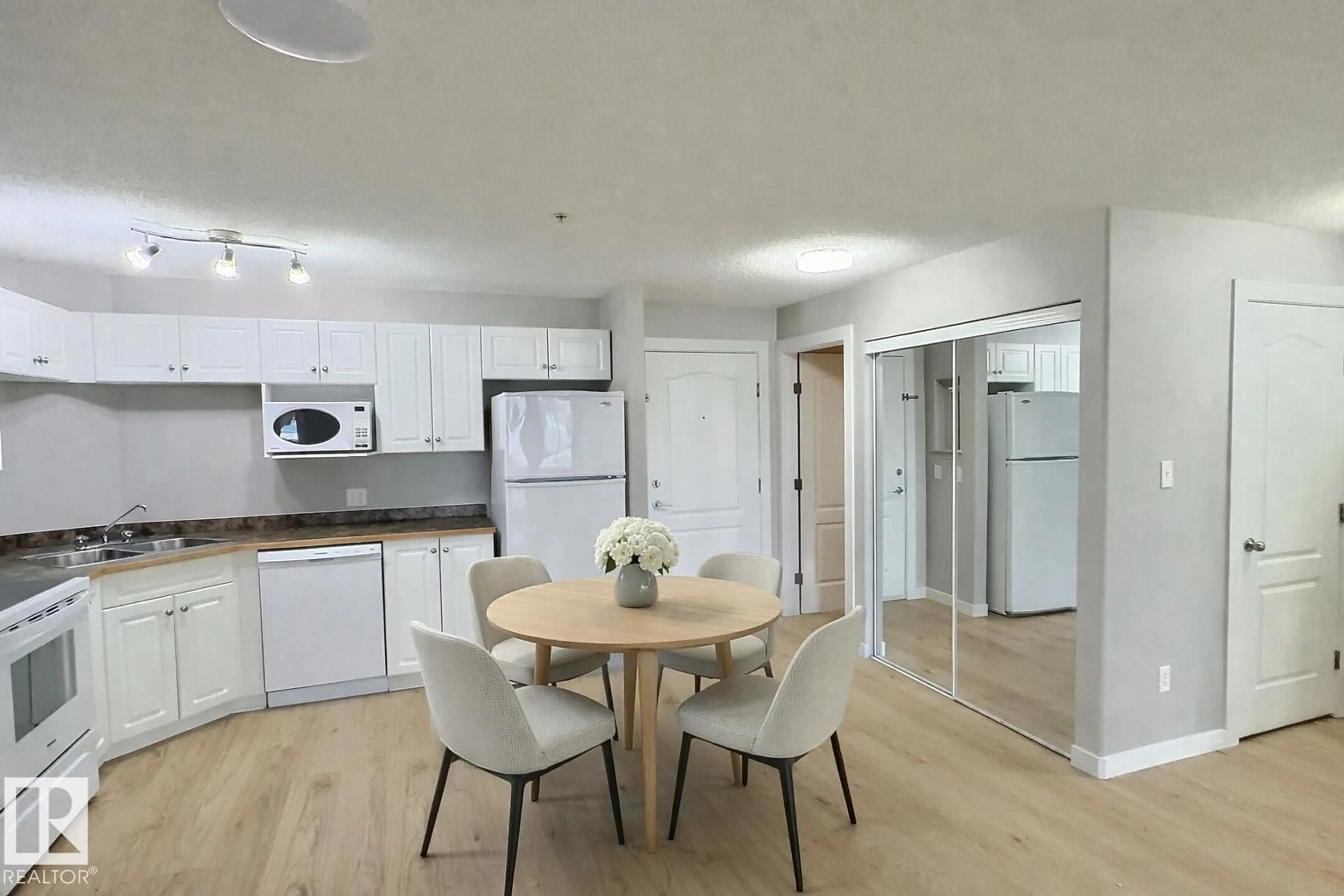 Open concept kitchen, wood/laminate floor for #103 - 5350 199 ST, Edmonton Alberta T6M0A4