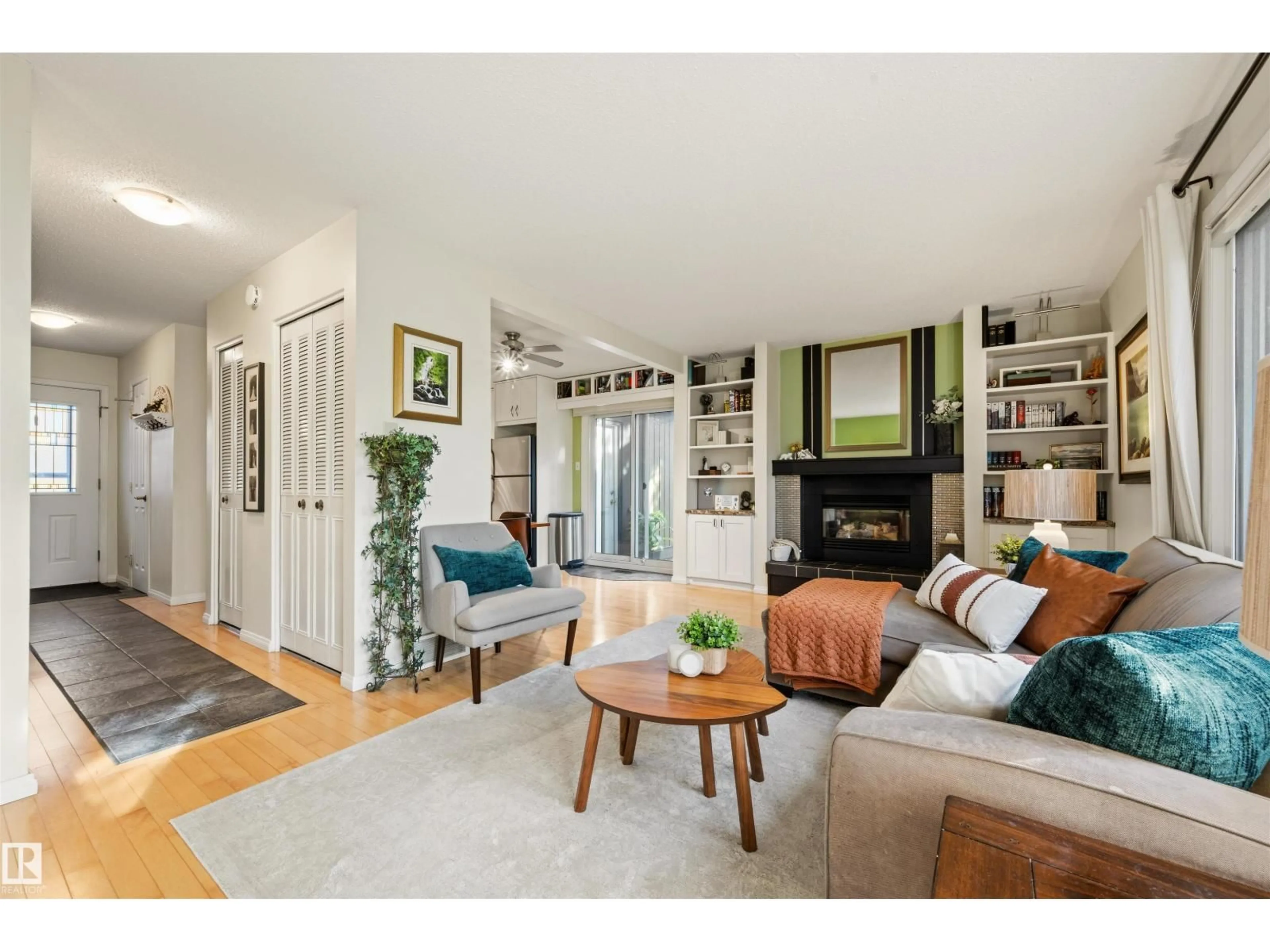 Living room with furniture, wood/laminate floor for 7067 32 AV, Edmonton Alberta T6K2K9