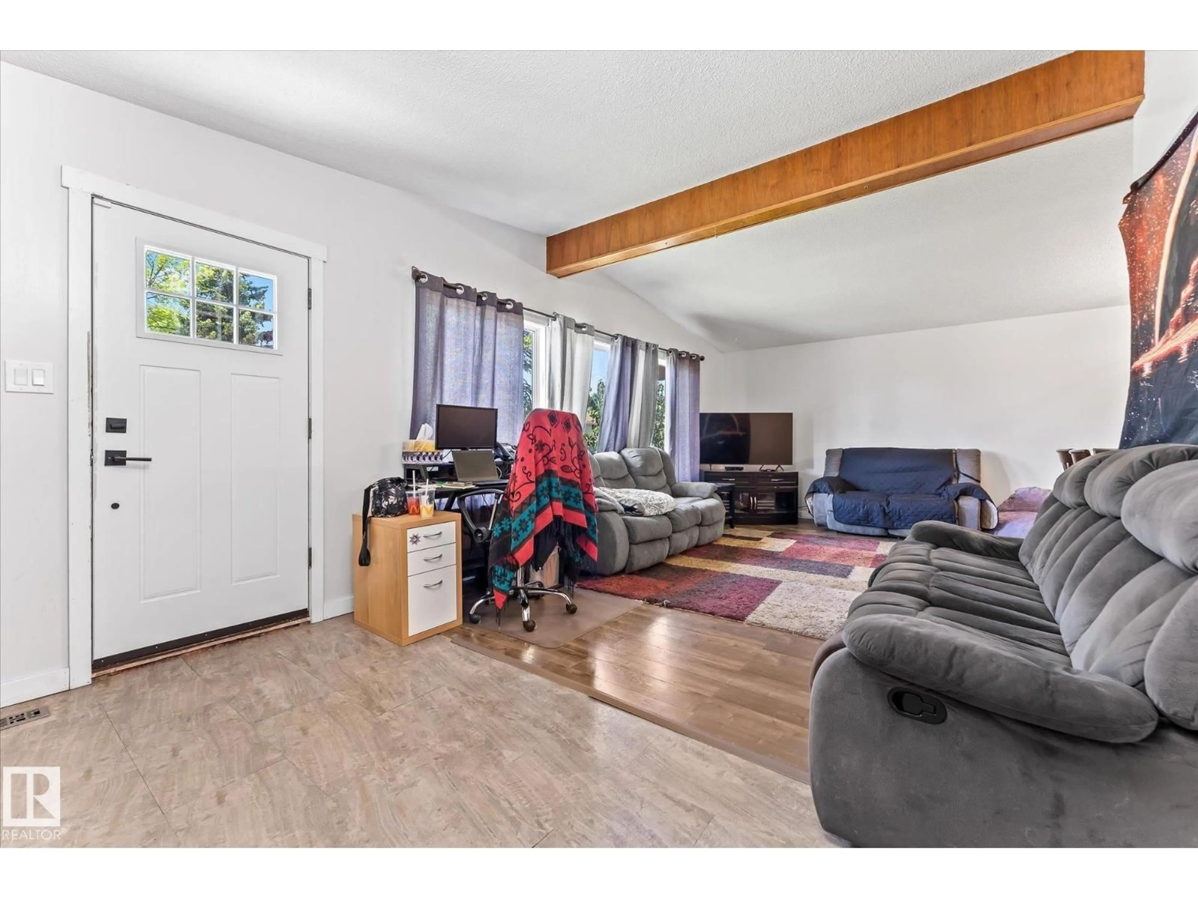 Living room with furniture, wood/laminate floor for 7308 149 AV, Edmonton Alberta T5C2V4
