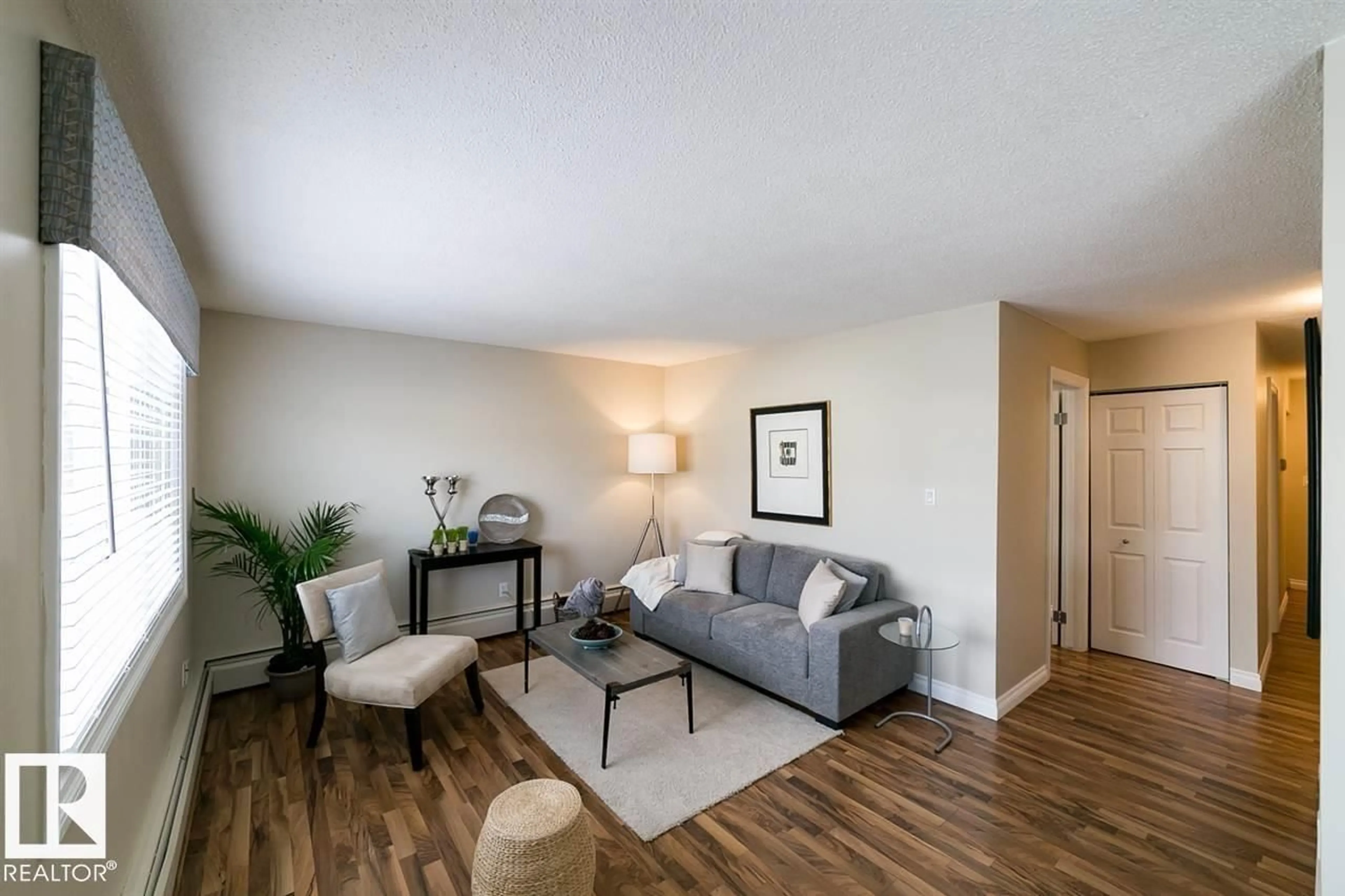 Living room with furniture, wood/laminate floor for 203 - 12223 82 ST, Edmonton Alberta T5B2W9