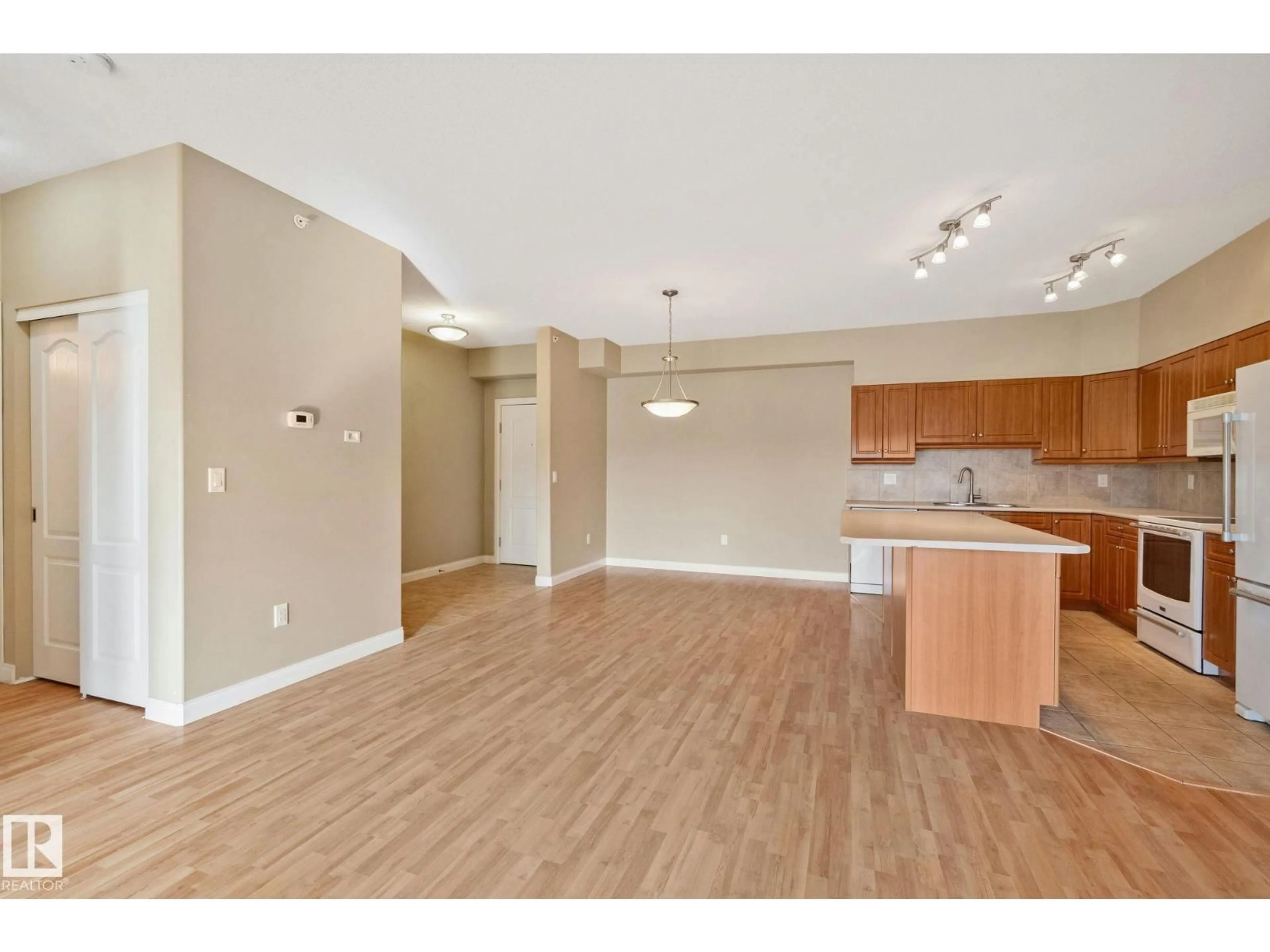 Open concept kitchen, wood/laminate floor for #413 - 1406 HODGSON WY, Edmonton Alberta T6R3K1