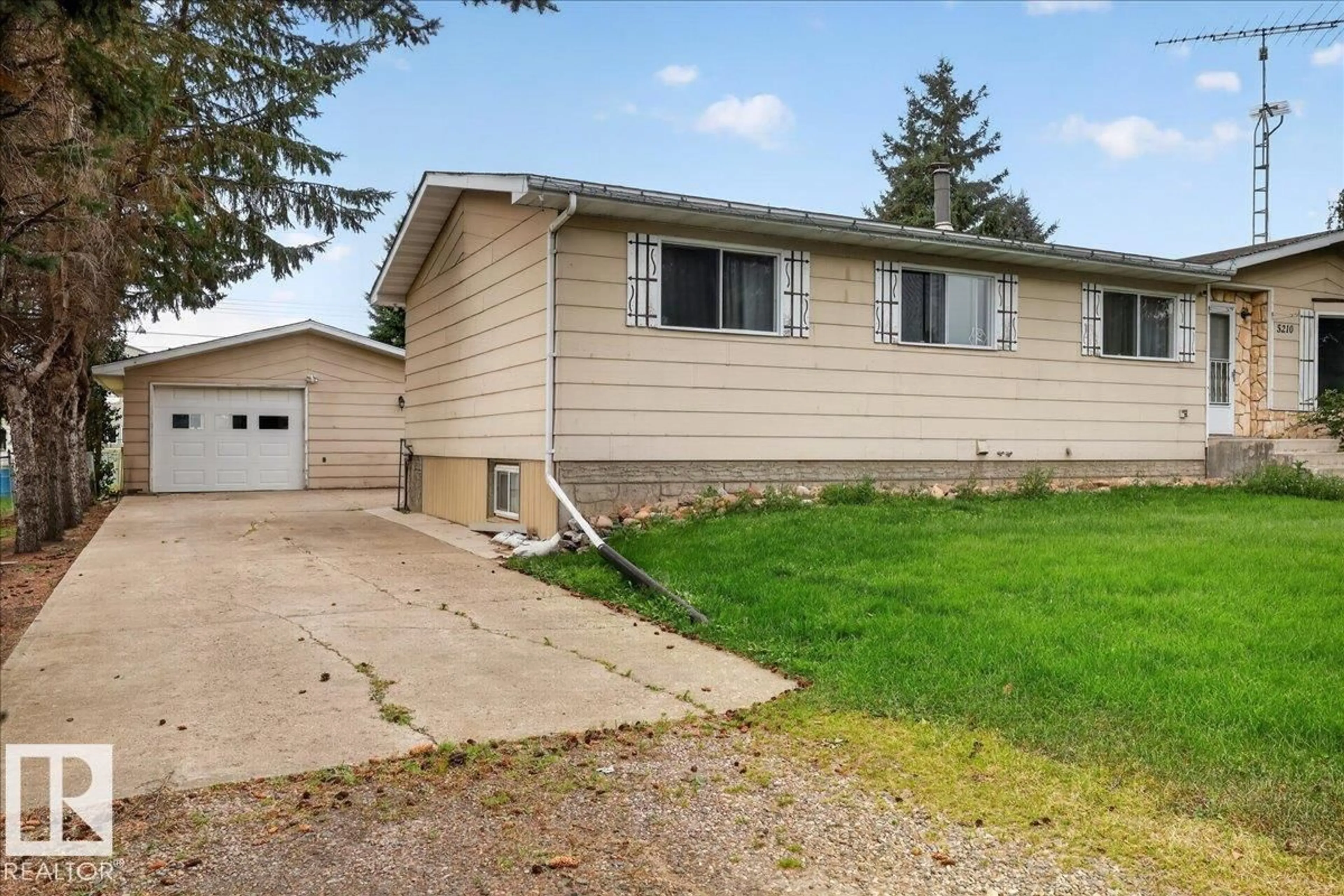 Home with vinyl exterior material, street for 5210 49 ST, Waskatenau Alberta T0A3P0
