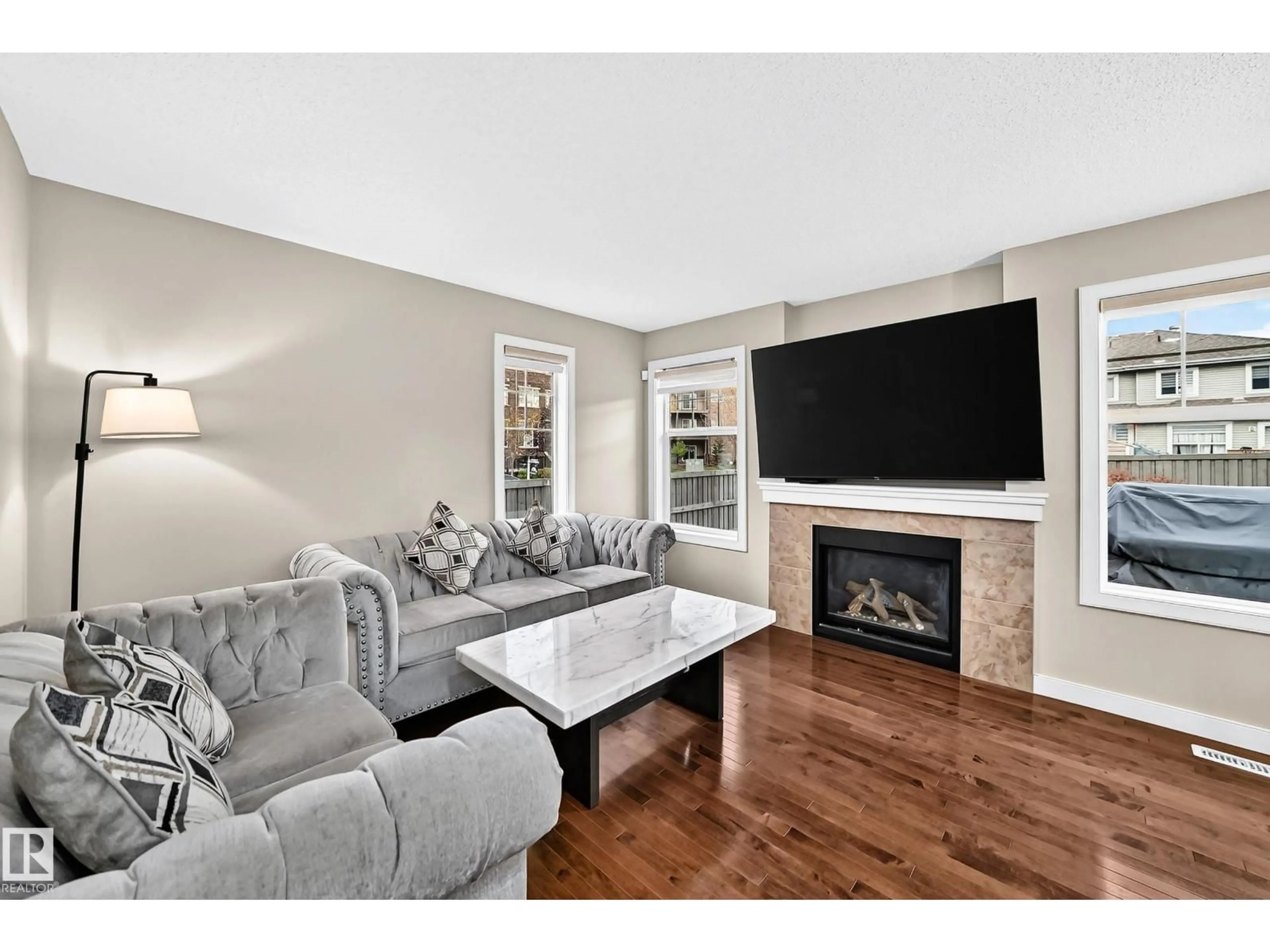 Living room with furniture, wood/laminate floor for SW - 1673 CUNNINGHAM WY, Edmonton Alberta T6W0W5