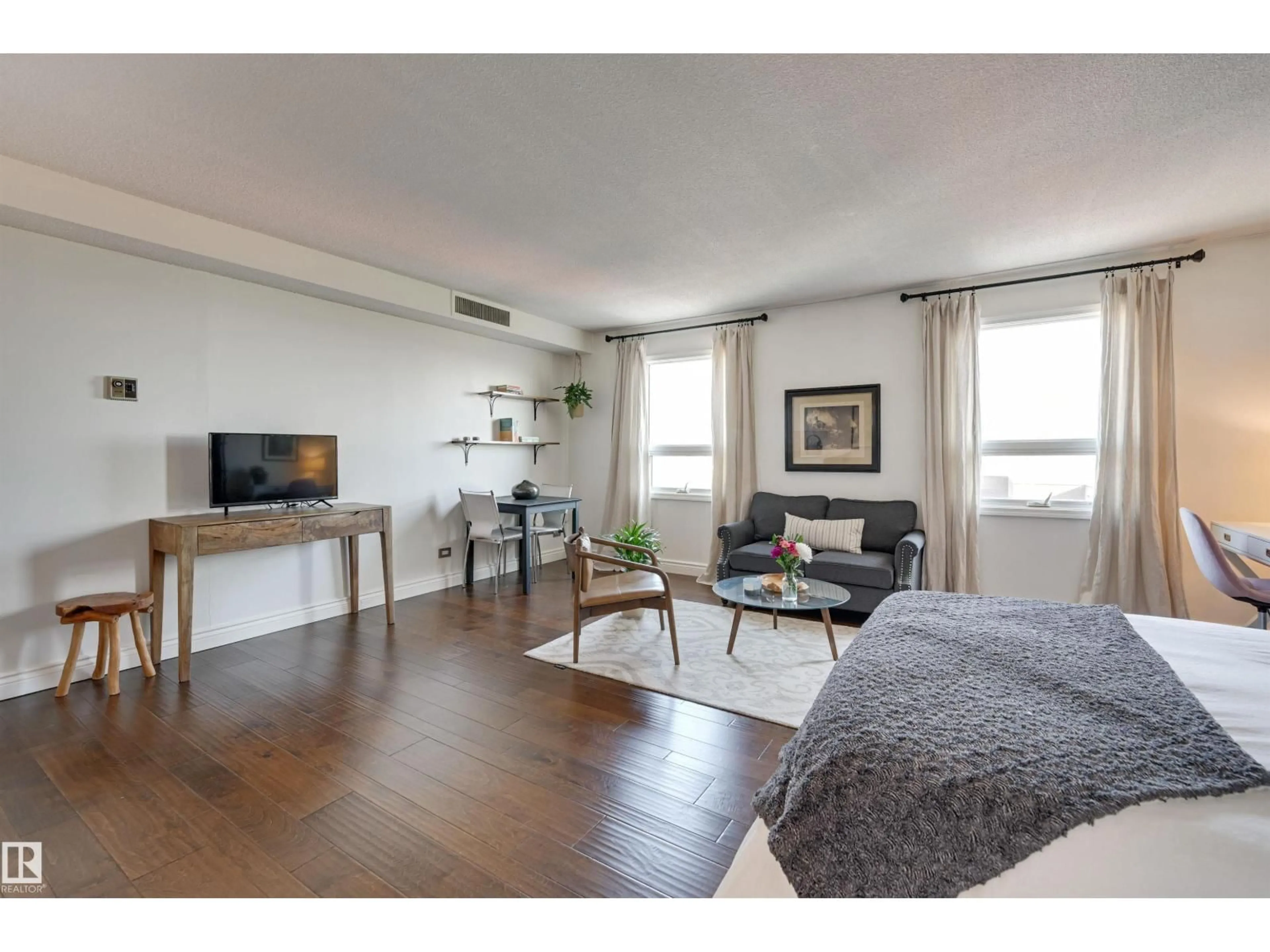 Living room with furniture, wood/laminate floor for 10140 NW - 1505 120 ST, Edmonton Alberta T5K1Z8