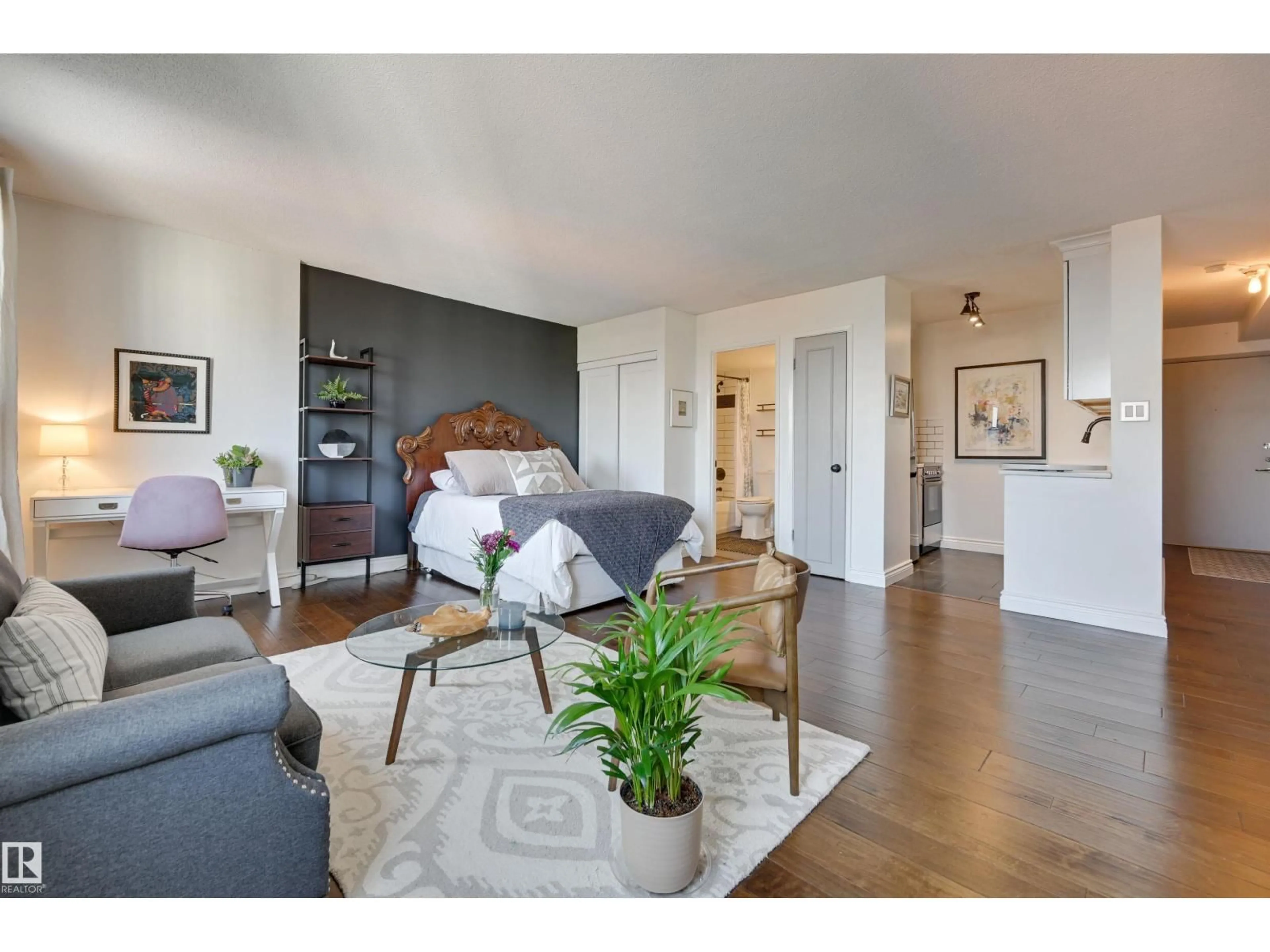 Living room with furniture, wood/laminate floor for 10140 NW - 1505 120 ST, Edmonton Alberta T5K1Z8