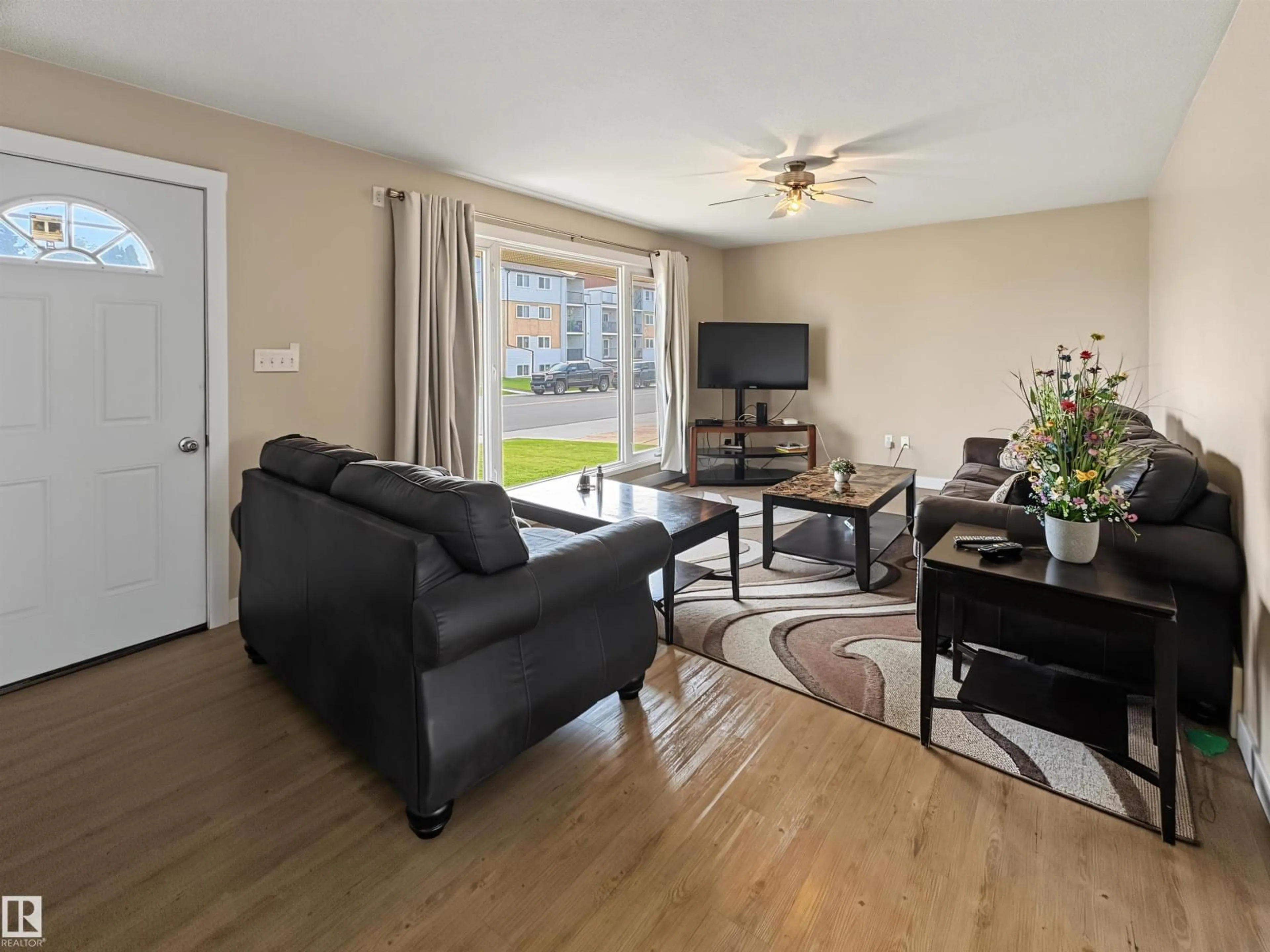 Living room with furniture, wood/laminate floor for 4816 54 ST, Bonnyville Town Alberta T9N1Y9