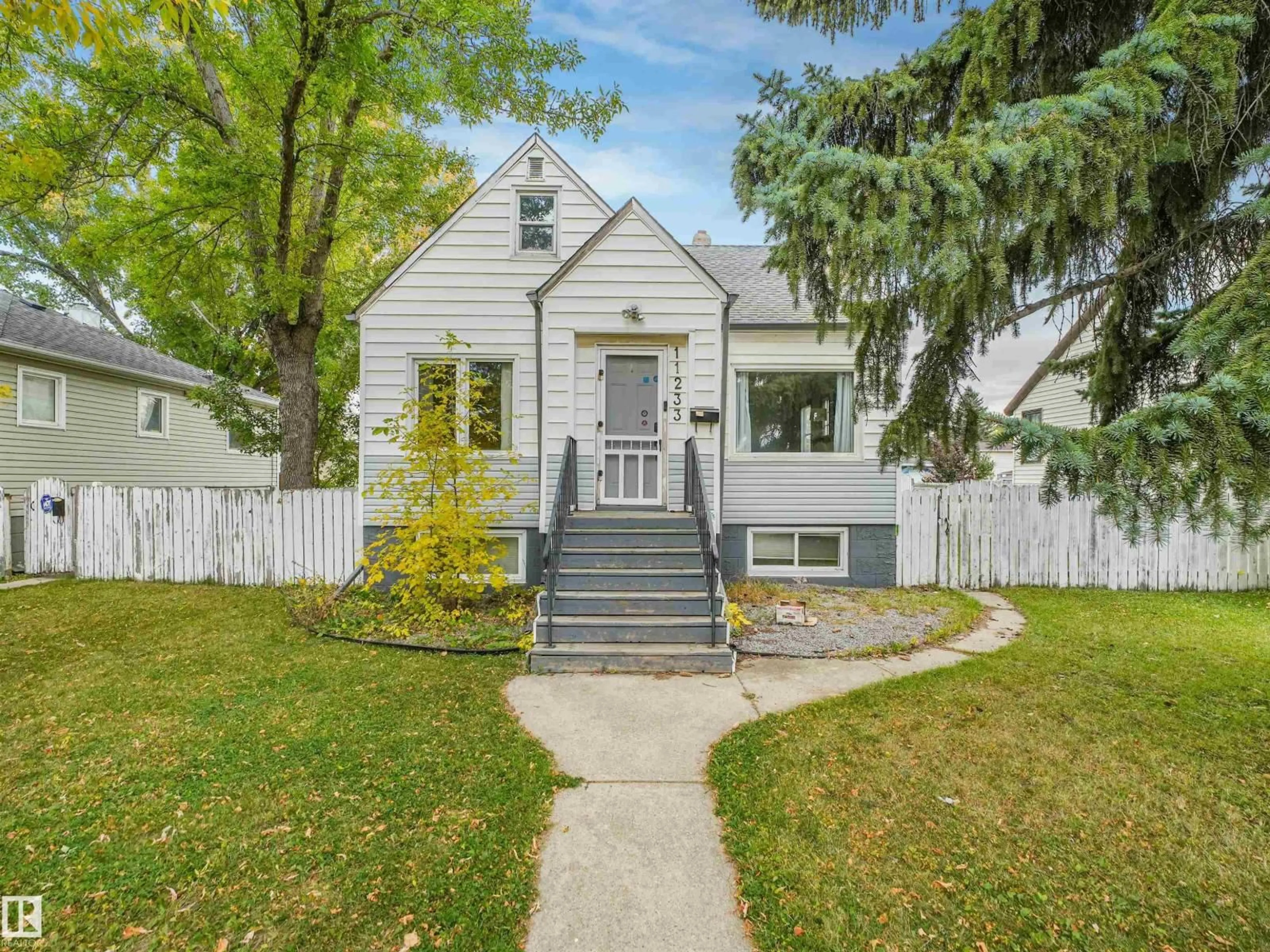Home with vinyl exterior material, street for NW - 11233 103 ST, Edmonton Alberta T5G2H6