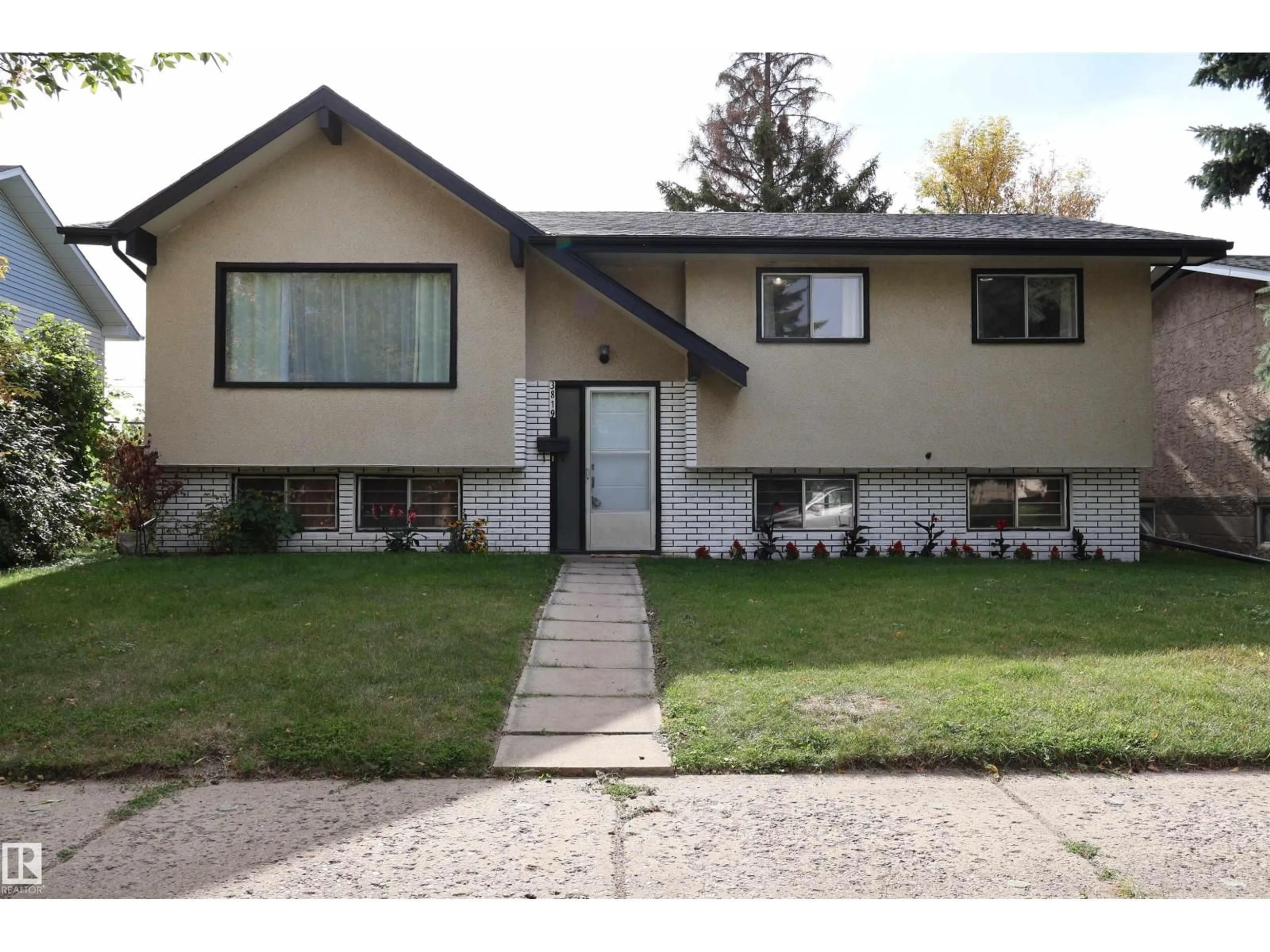 Home with vinyl exterior material, street for NW - 3819 115 AV, Edmonton Alberta T5W0V2