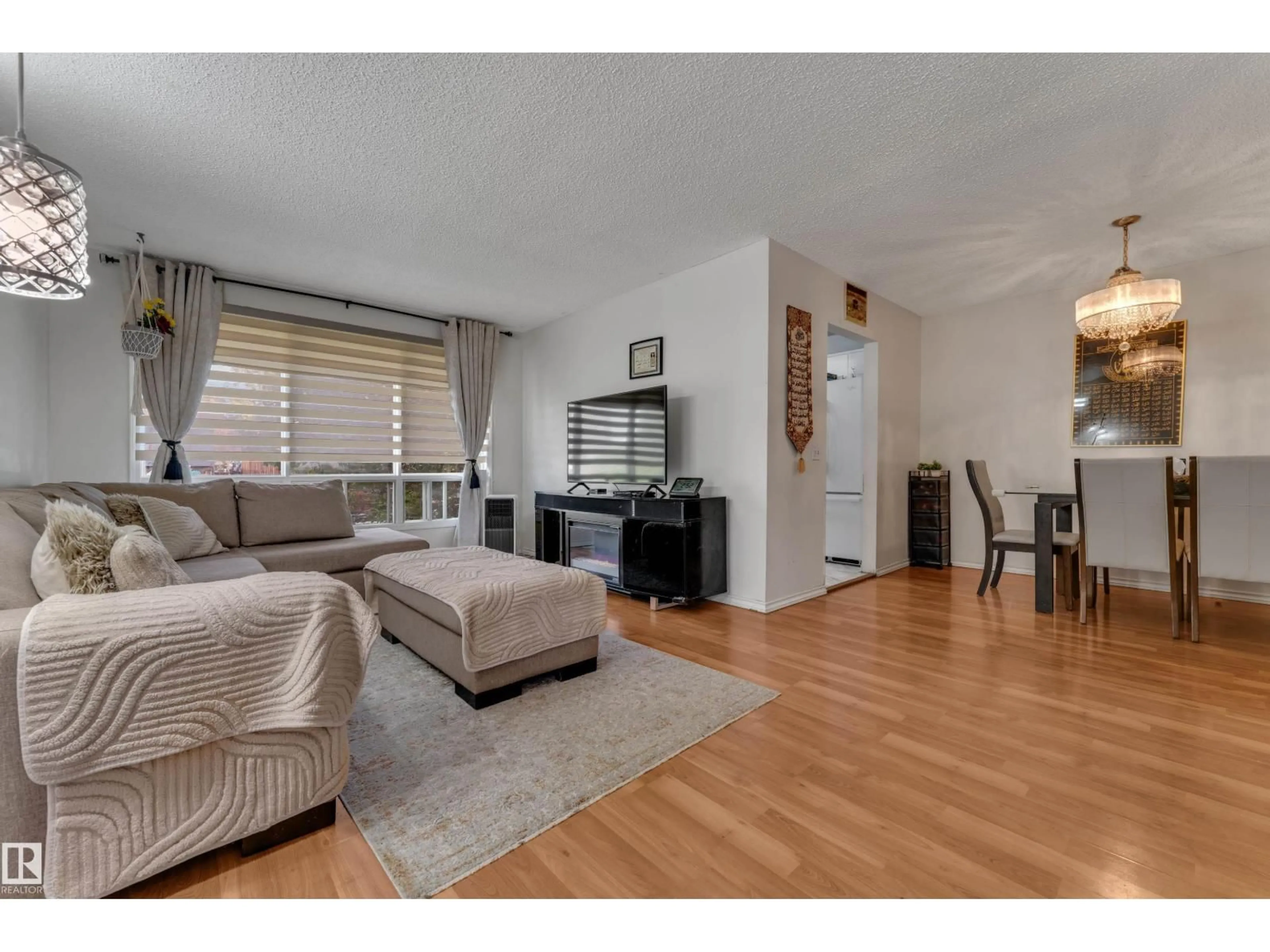 Living room with furniture, wood/laminate floor for 2114 38 ST, Edmonton Alberta T6L4C3