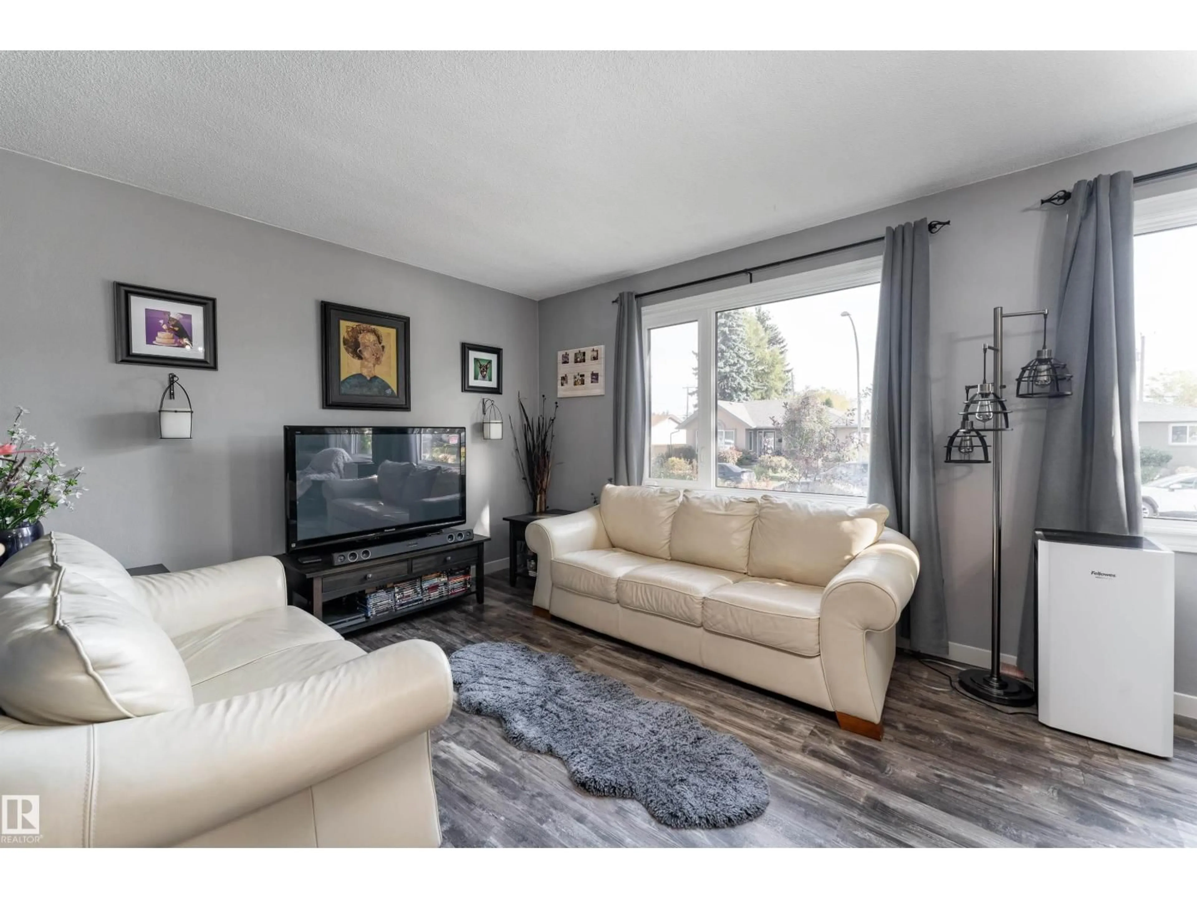Living room with furniture, wood/laminate floor for 13220 77 ST, Edmonton Alberta T5C1C9