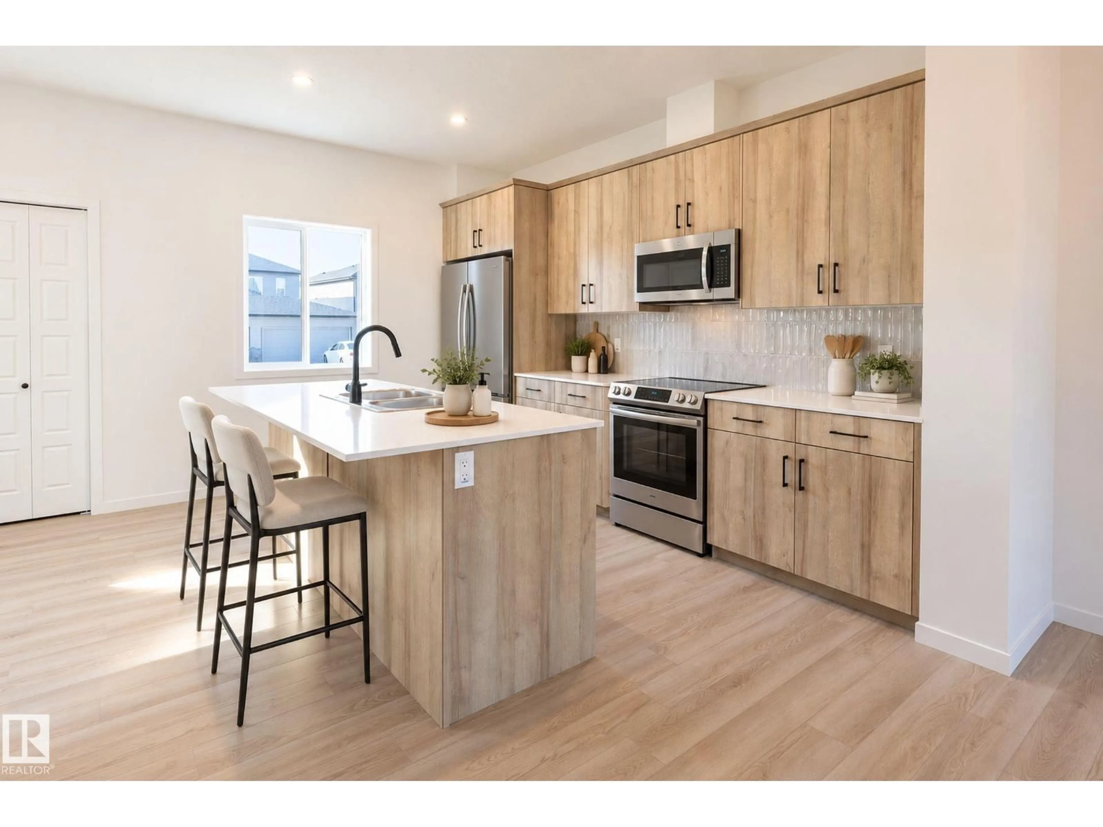 Open concept kitchen, wood/laminate floor for 213 WATTLE RD, Leduc Alberta T9E0V1