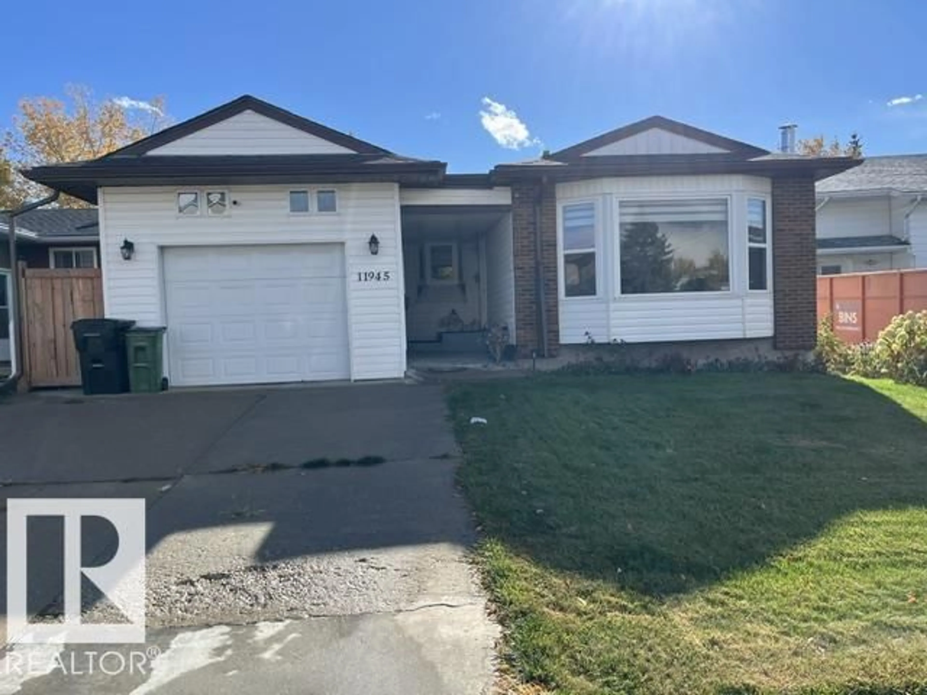Home with vinyl exterior material, street for 11945 138 AV, Edmonton Alberta T5X4K1