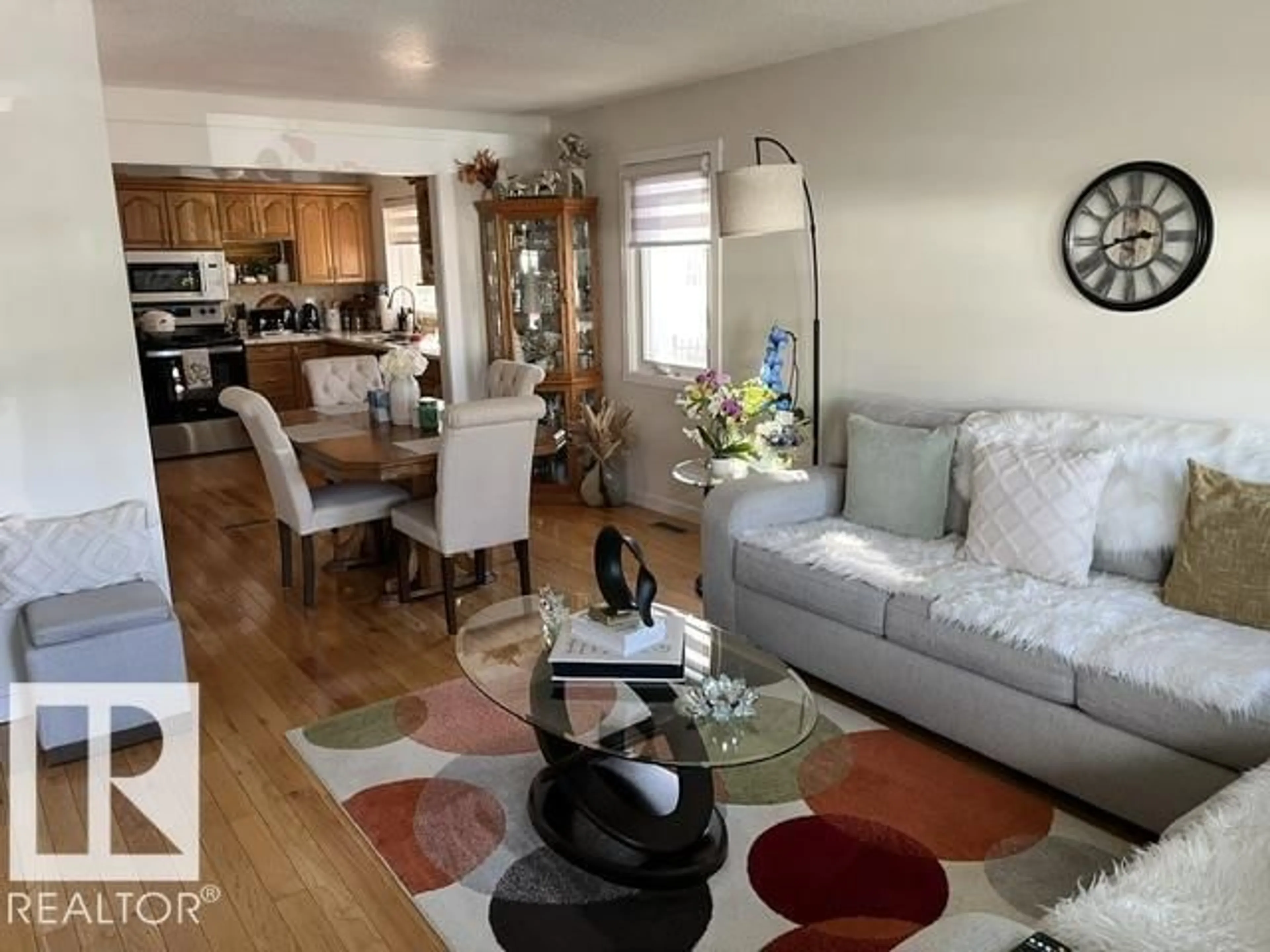 Living room with furniture, wood/laminate floor for 11945 138 AV, Edmonton Alberta T5X4K1
