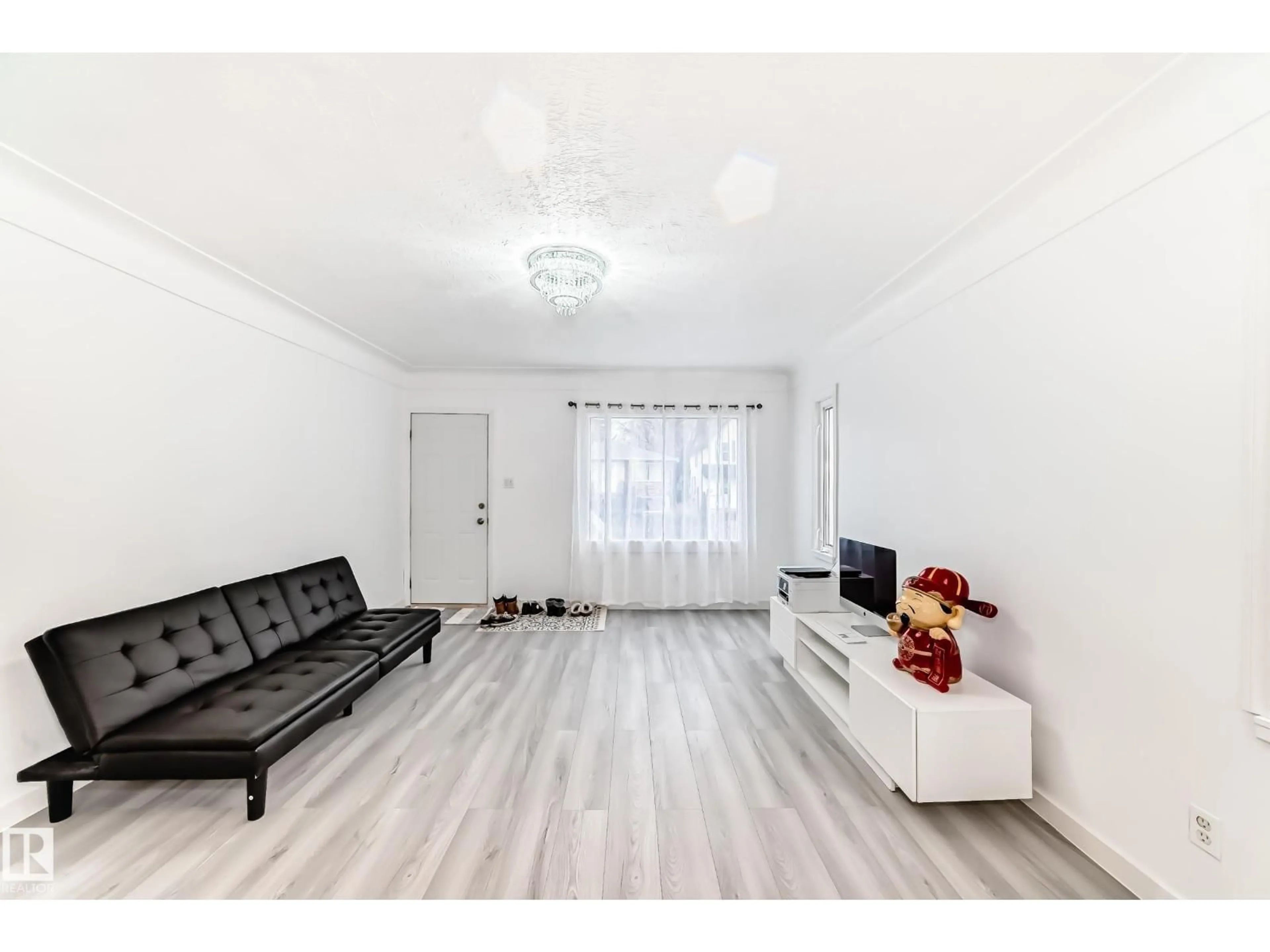 Living room with furniture, wood/laminate floor for 9221 110 AV NW, Edmonton Alberta T5H1H2
