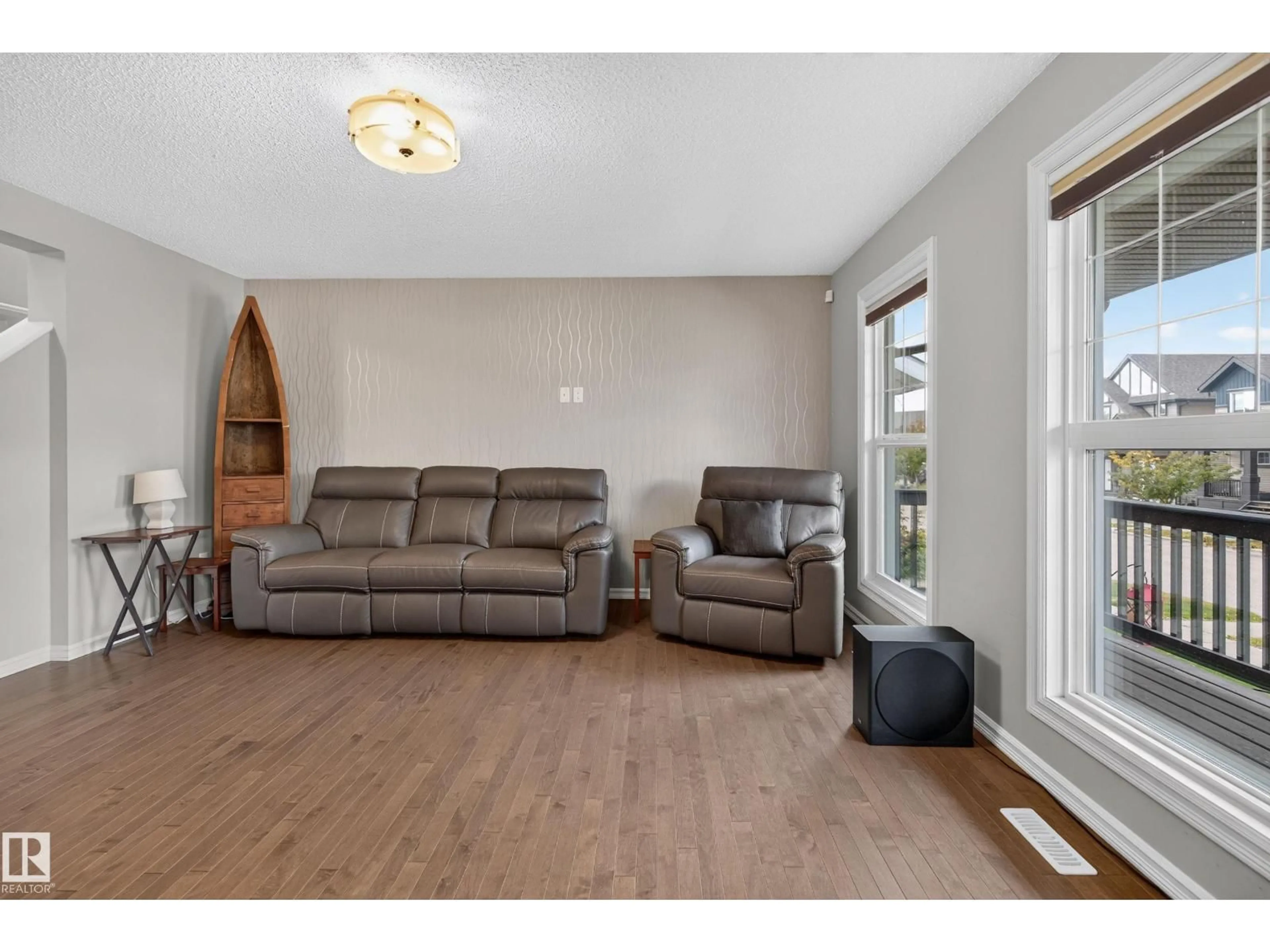 Living room with furniture, wood/laminate floor for 821 36A AV NW, Edmonton Alberta T6T0S5