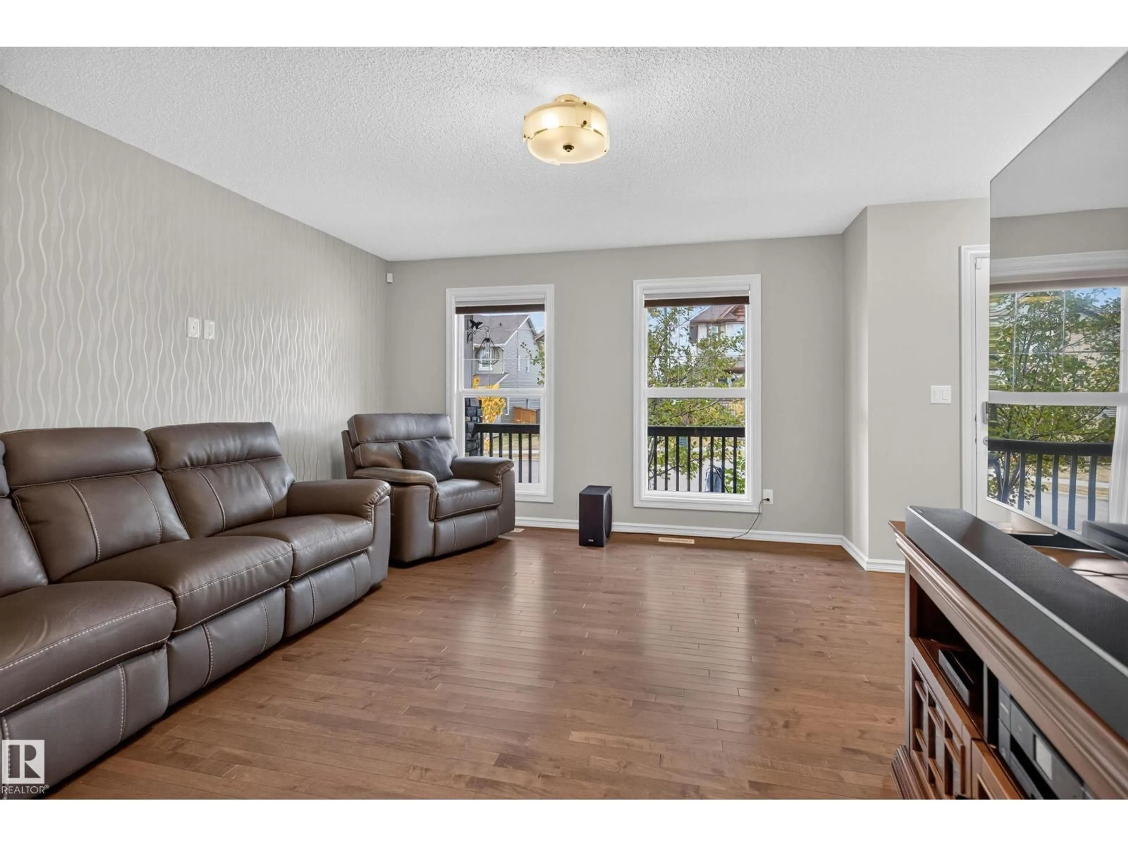Living room with furniture, wood/laminate floor for 821 36A AV NW, Edmonton Alberta T6T0S5