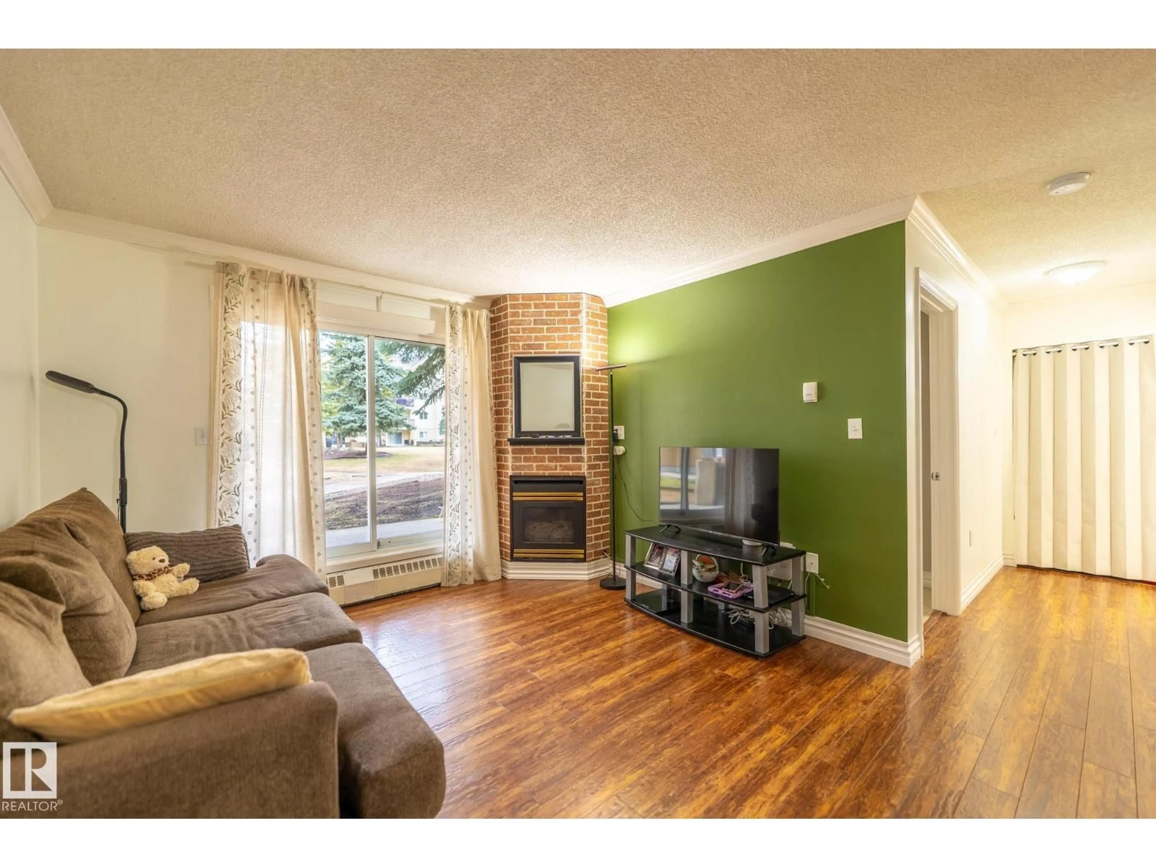 Living room with furniture, wood/laminate floor for #142 - 10636 120 ST, Edmonton Alberta T5H4L5