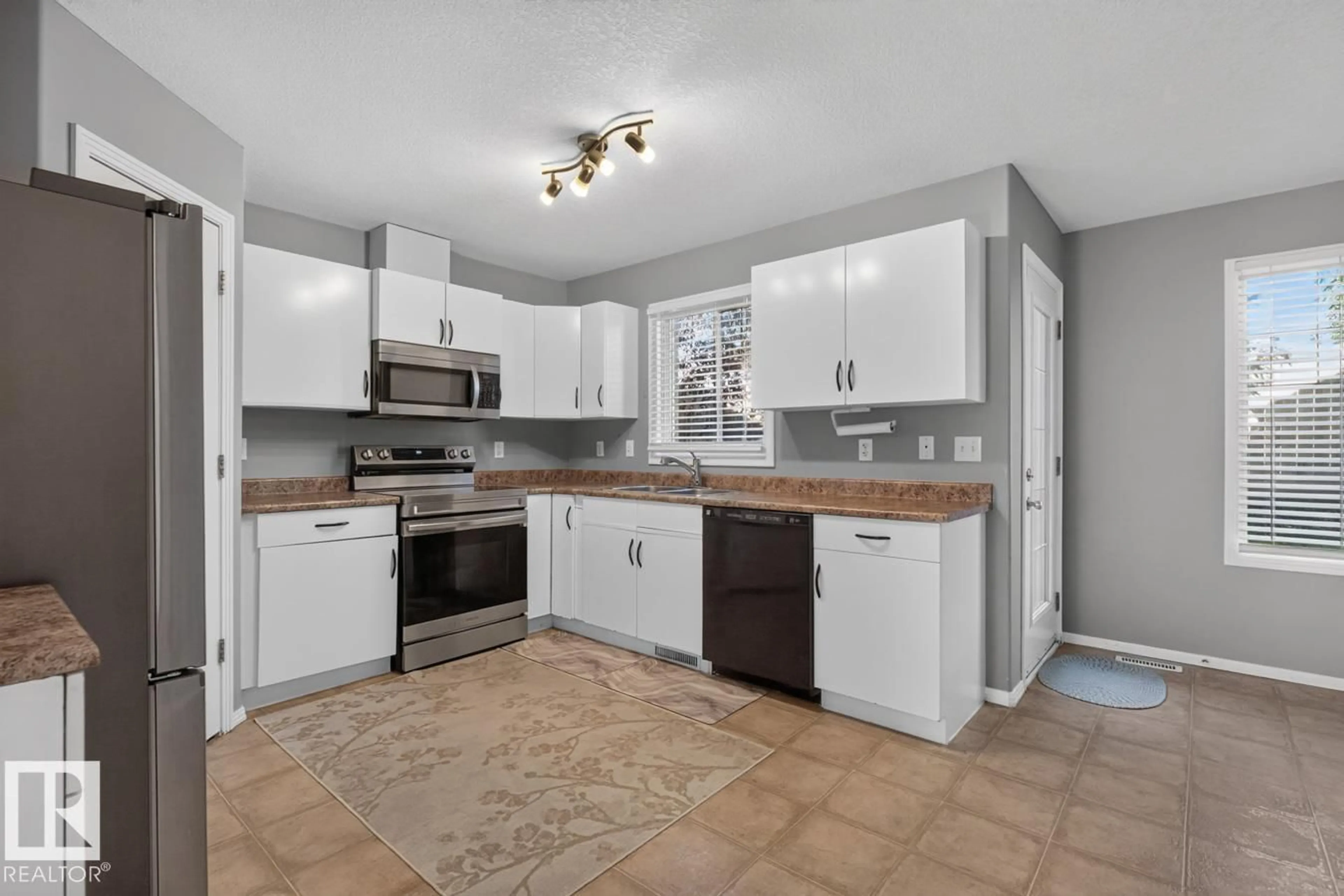 Open concept kitchen, ceramic/tile floor for #11 - 12930 140 AV NW, Edmonton Alberta T6V0C4