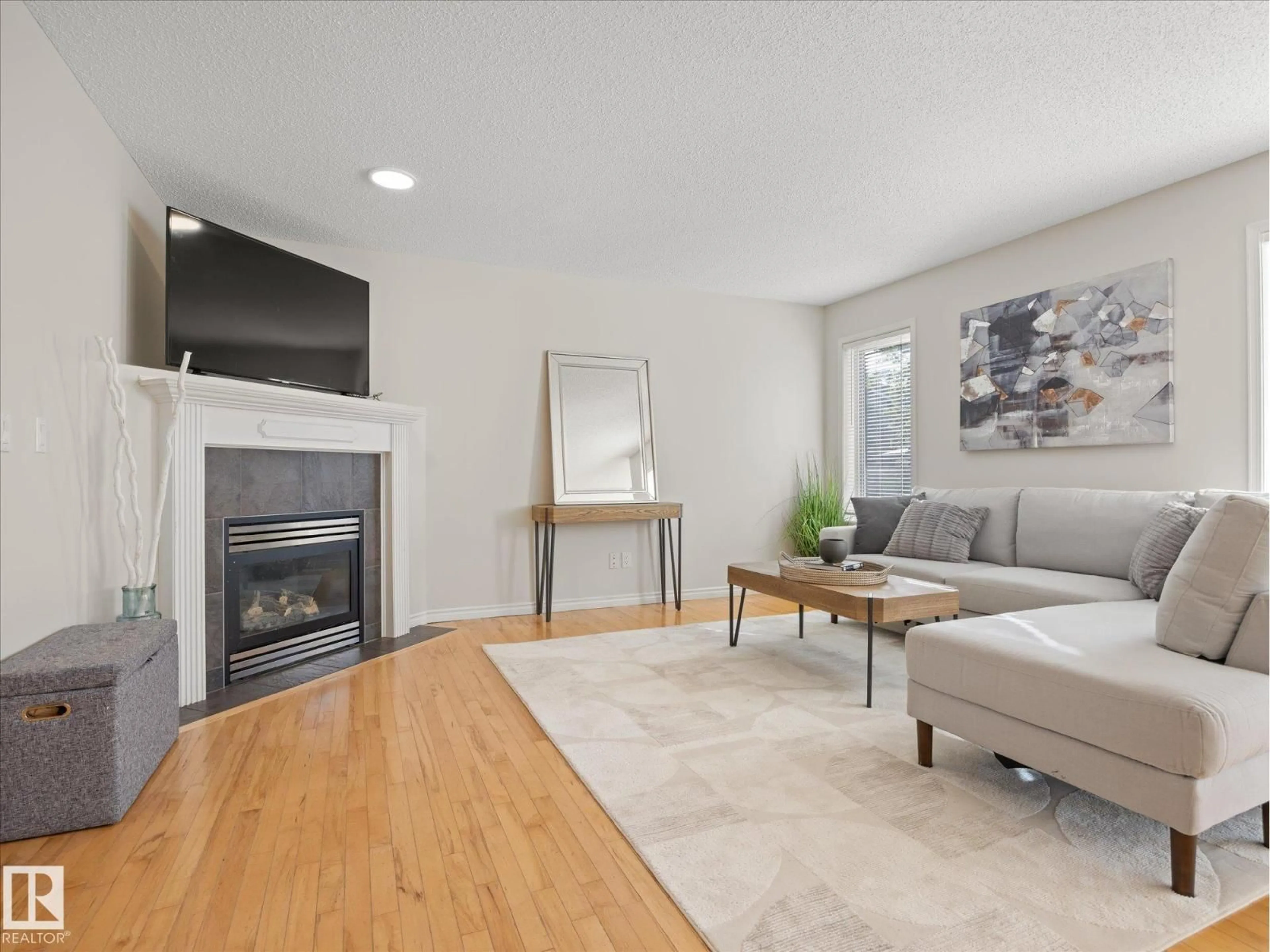 Living room with furniture, wood/laminate floor for 11531 11 AV, Edmonton Alberta T6W1W7