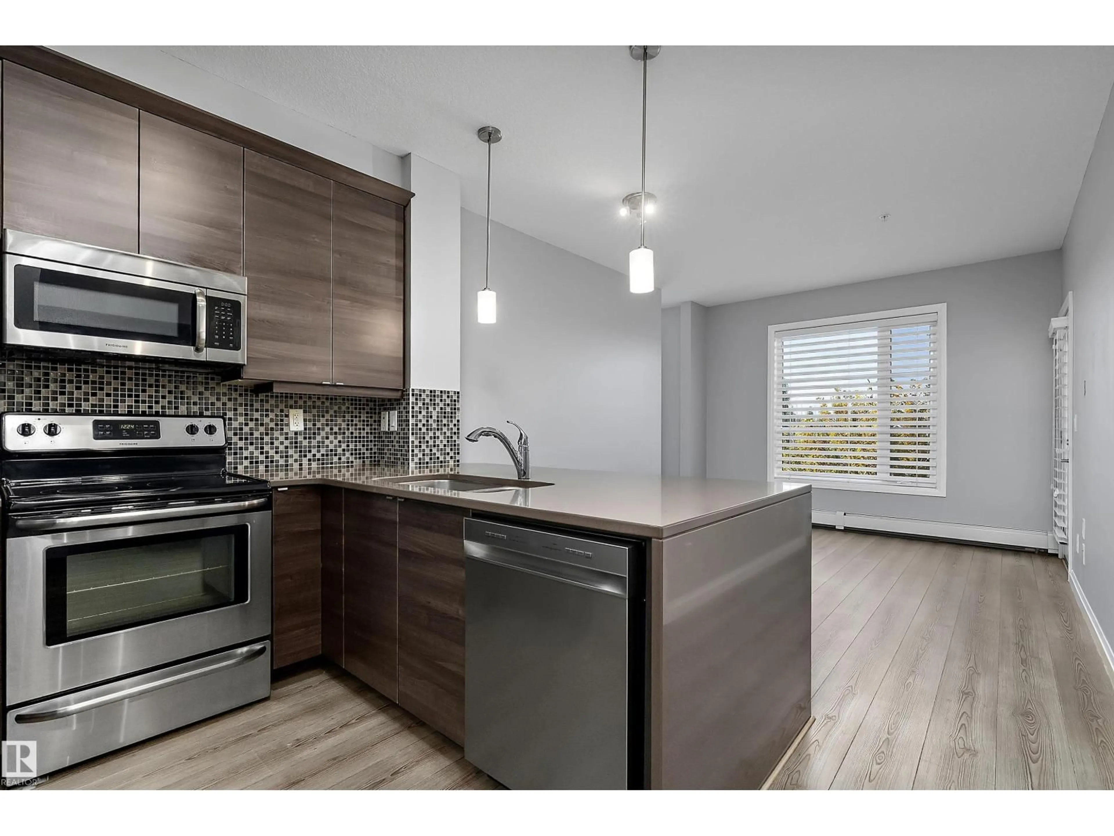 Open concept kitchen, wood/laminate floor for 311 - 2590 ANDERSON WY, Edmonton Alberta T6W0R2