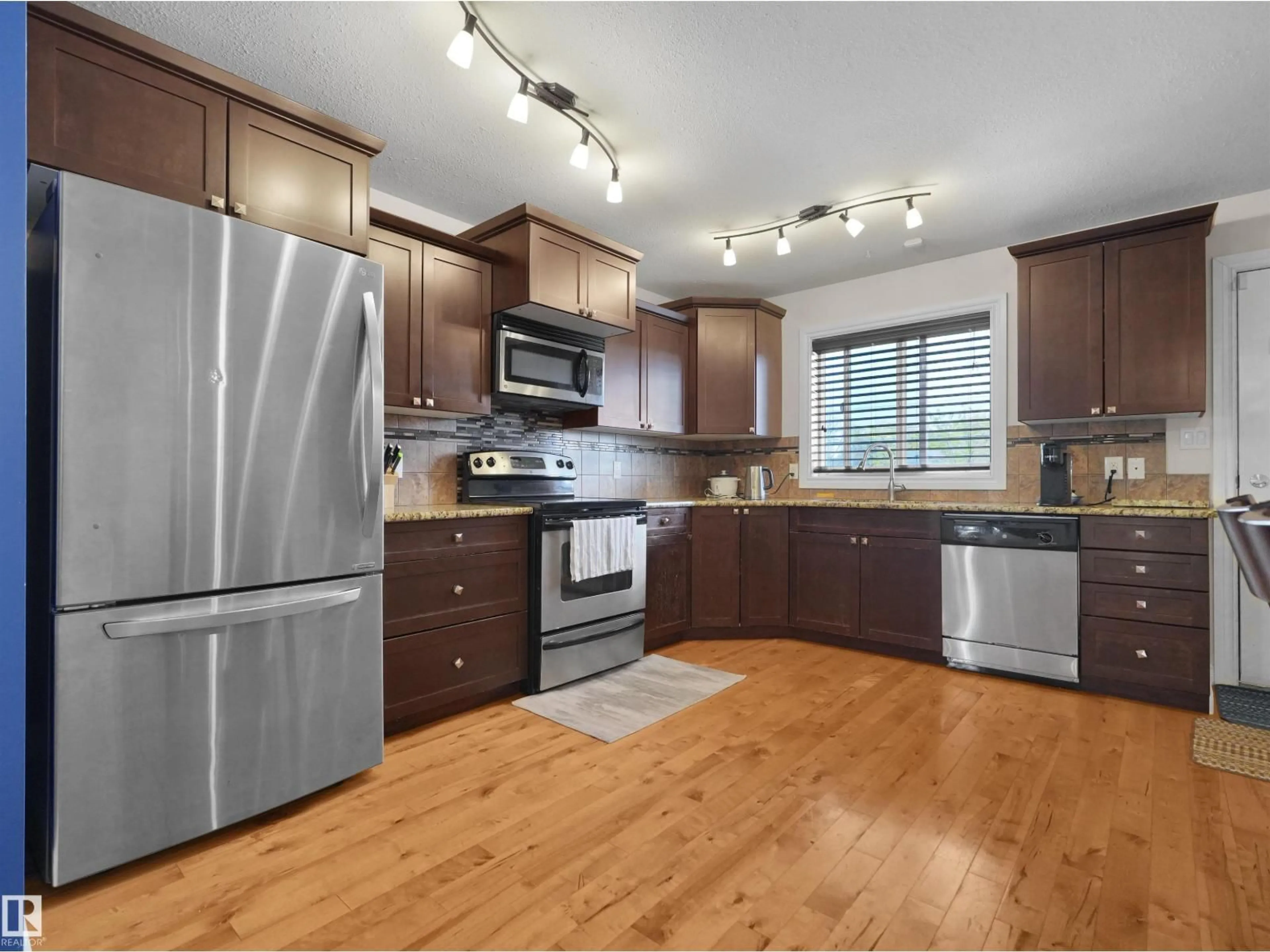 Open concept kitchen, wood/laminate floor for 11841 94 ST, Edmonton Alberta T5G1J3