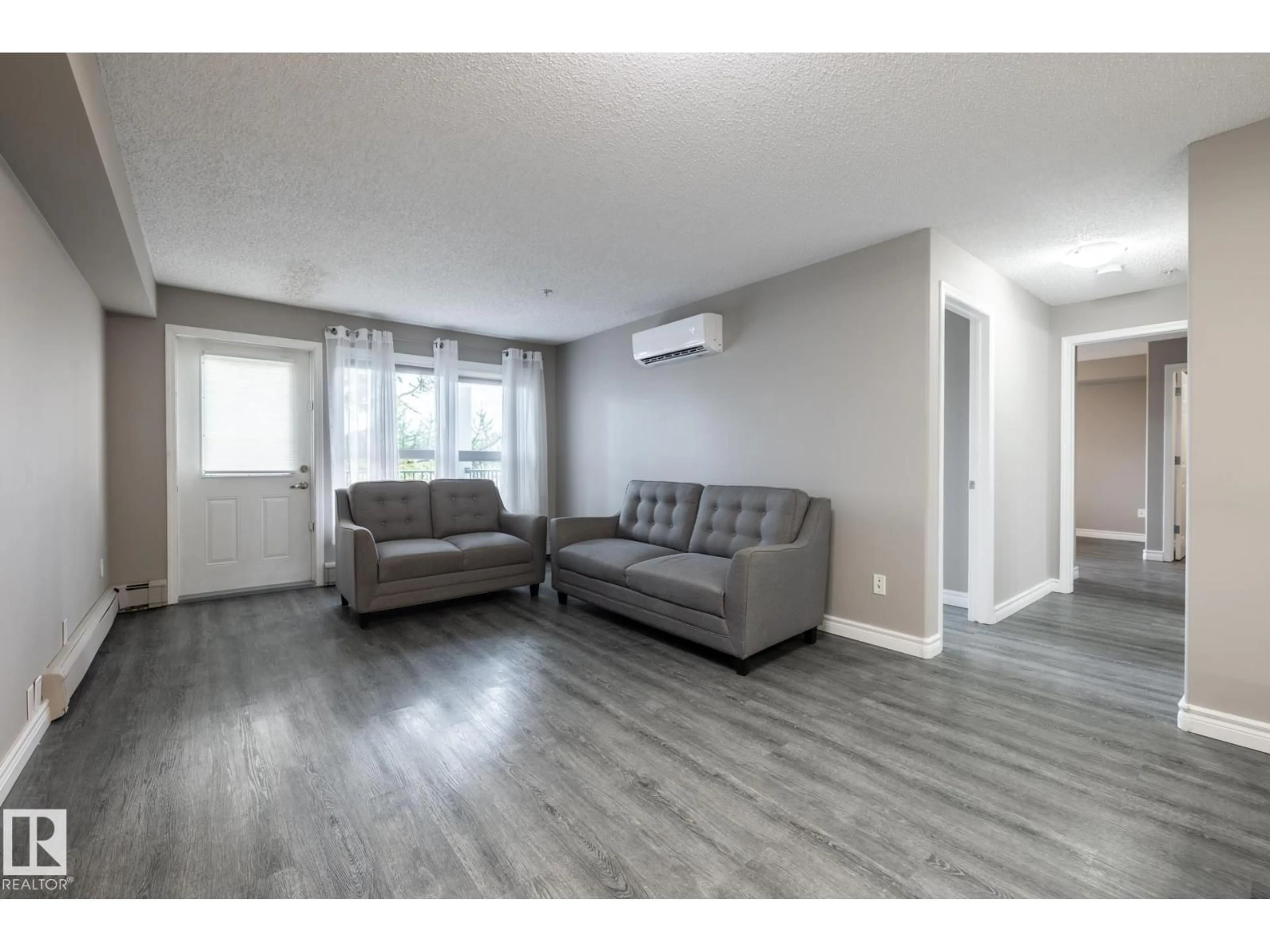 Living room with furniture, wood/laminate floor for 310 - 13635 34 ST, Edmonton Alberta T5A0C4