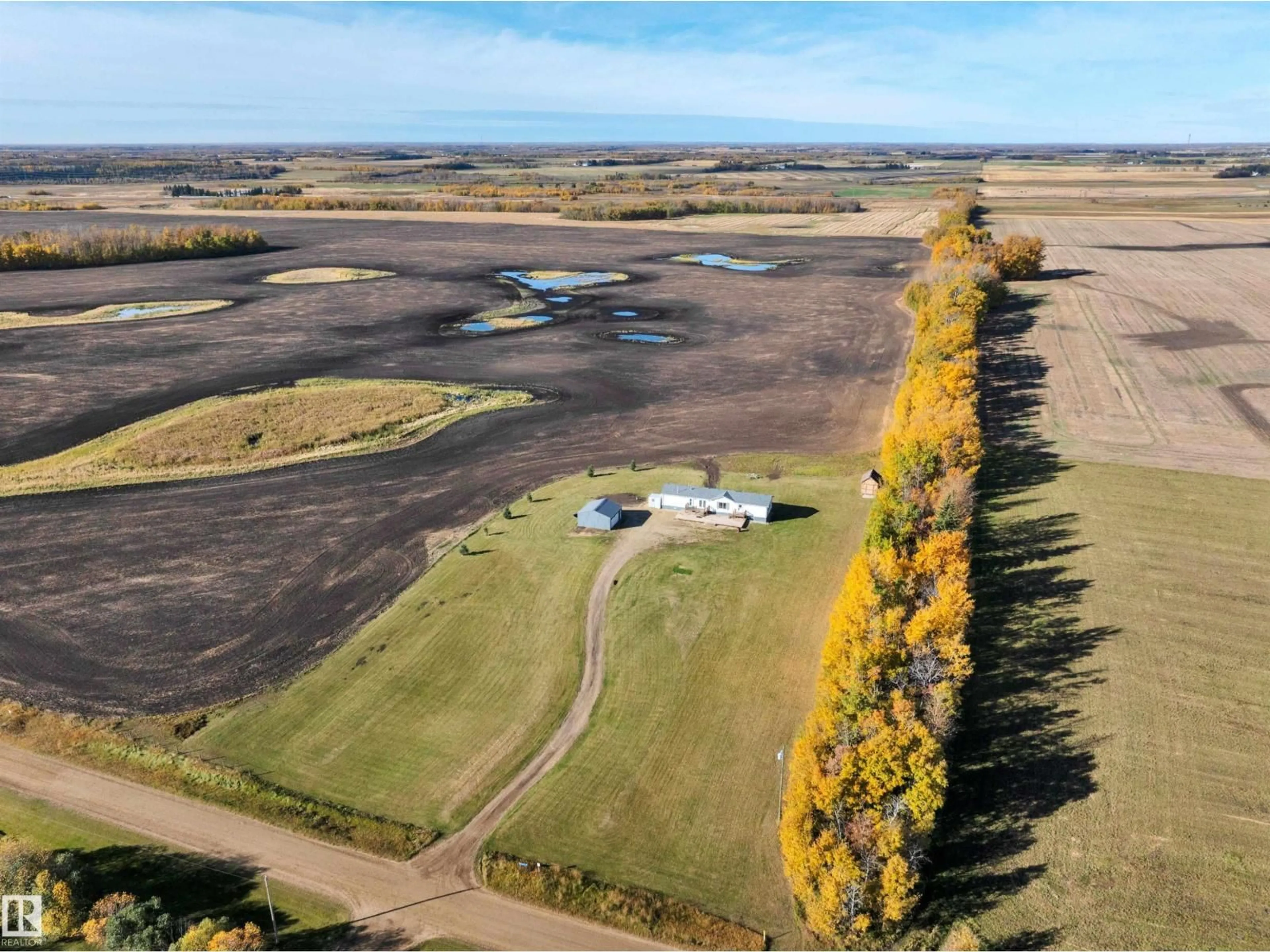A pic from outside/outdoor area/front of a property/back of a property/a pic from drone, water/lake/river/ocean view for 48138 RGE RD 244, Rural Leduc County Alberta T4X2S6