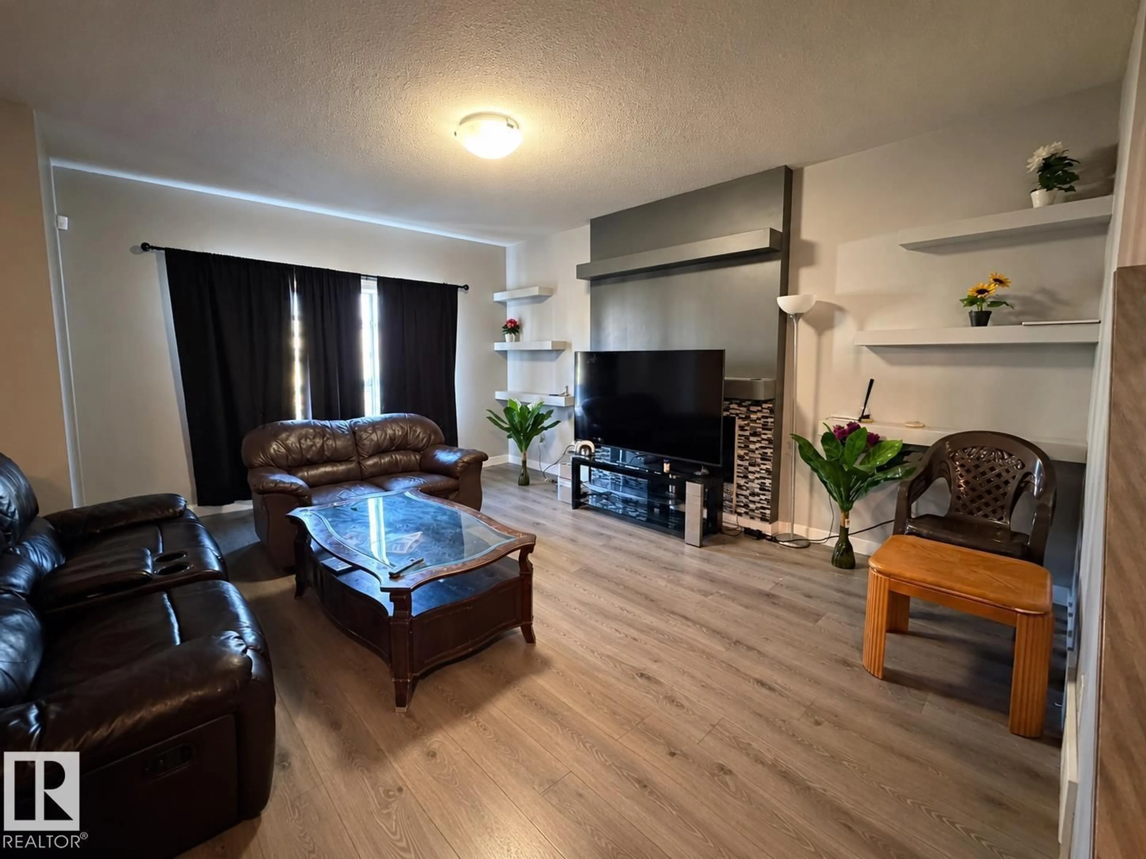 Living room with furniture, wood/laminate floor for 424 42 AV, Edmonton Alberta T6T2G1