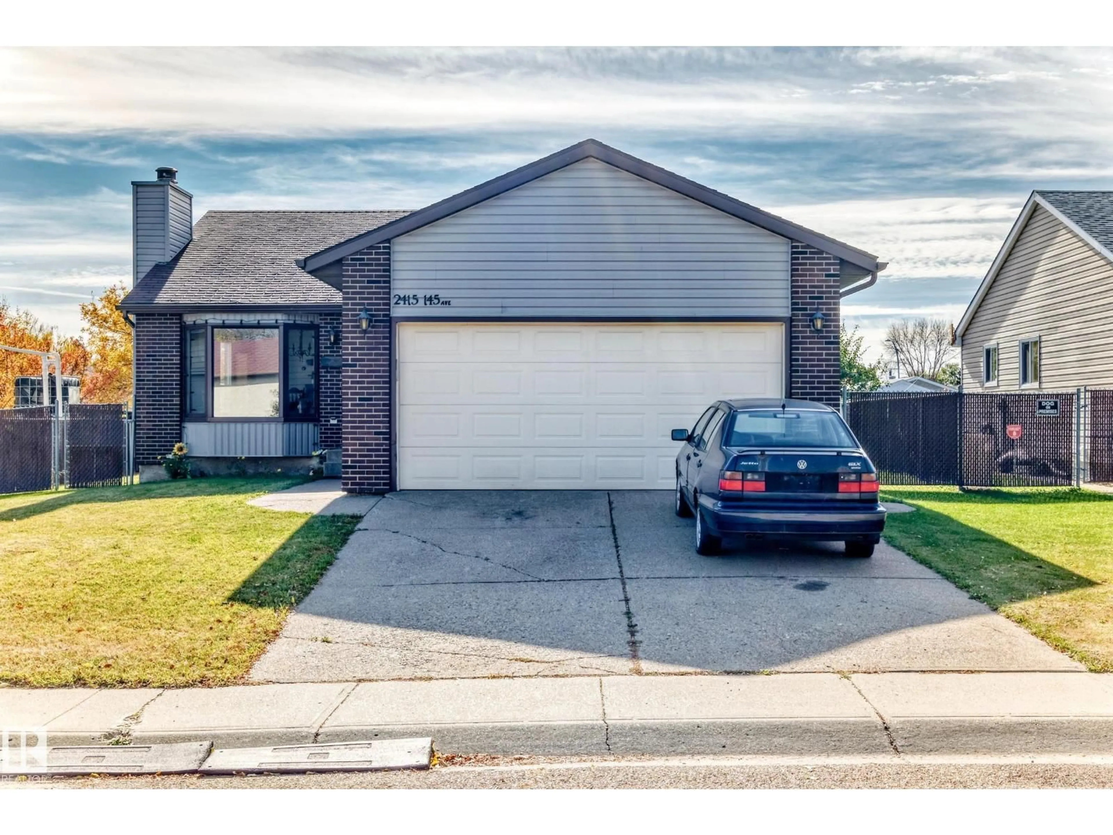 Home with vinyl exterior material, street for NW - 2415 145 AV, Edmonton Alberta T5Y2J5