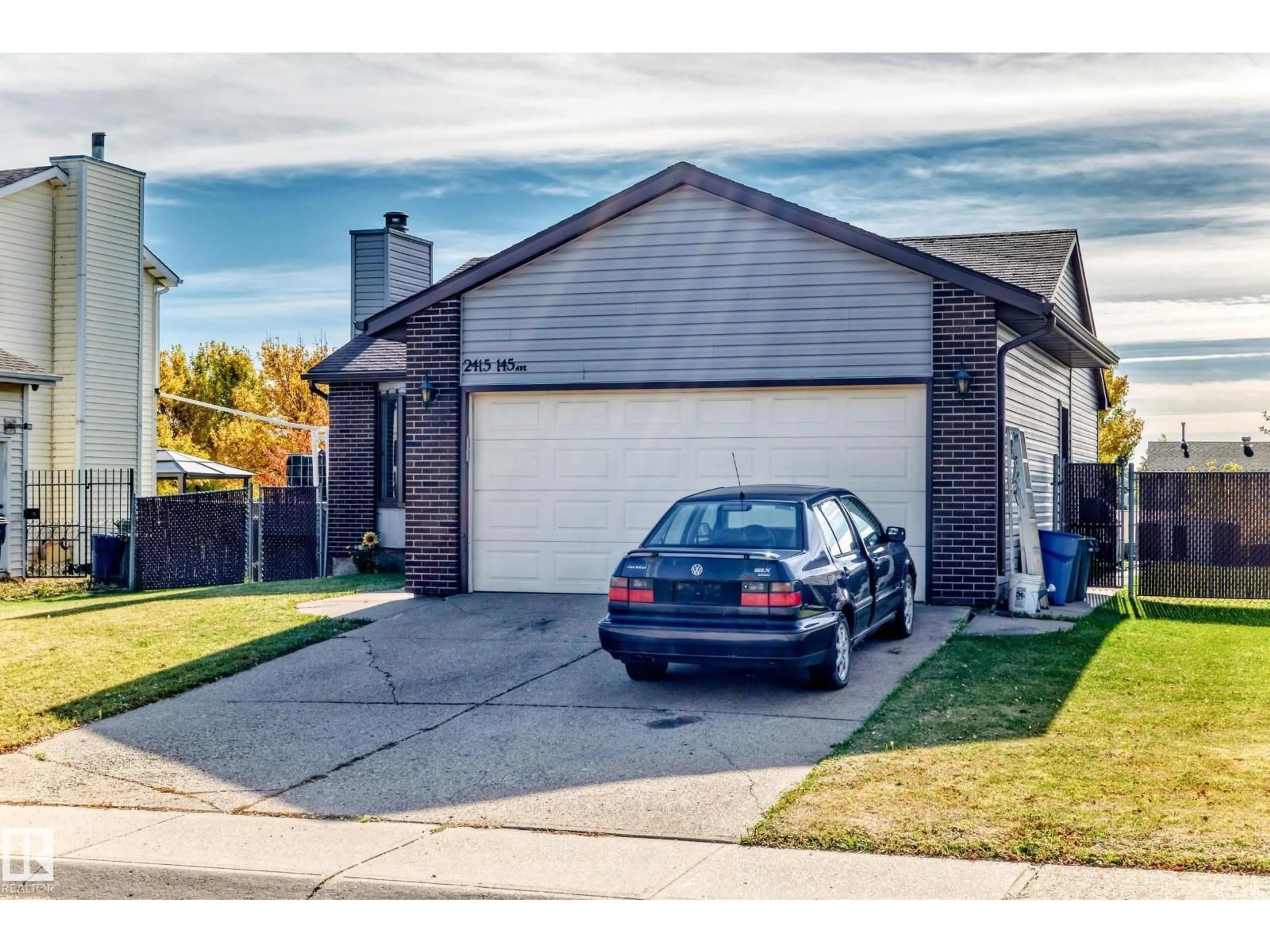 Home with vinyl exterior material, street for NW - 2415 145 AV, Edmonton Alberta T5Y2J5