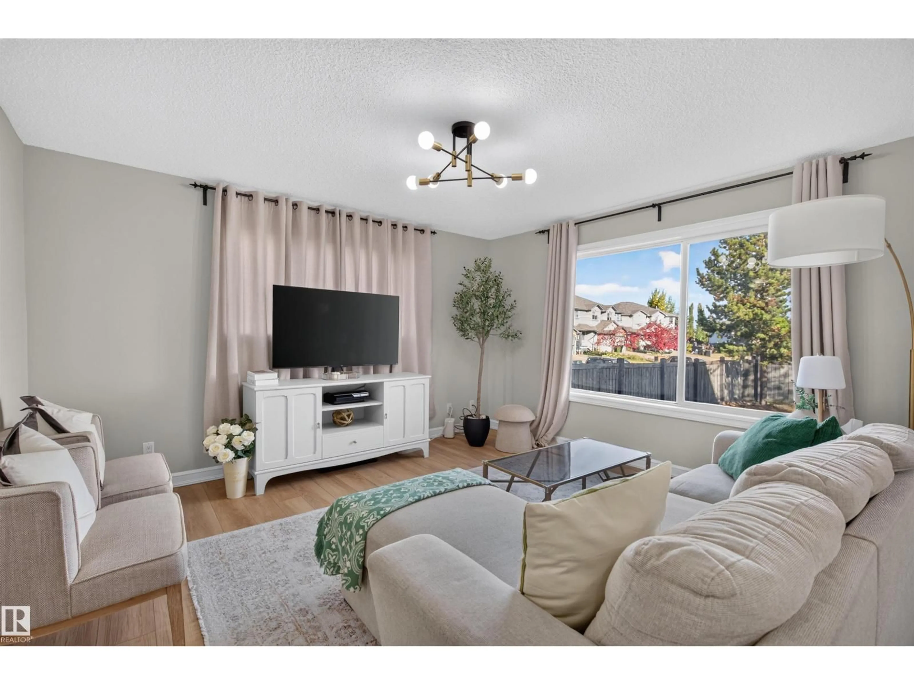 Living room with furniture, wood/laminate floor for 1304 BARNES CL, Edmonton Alberta T6W1E5