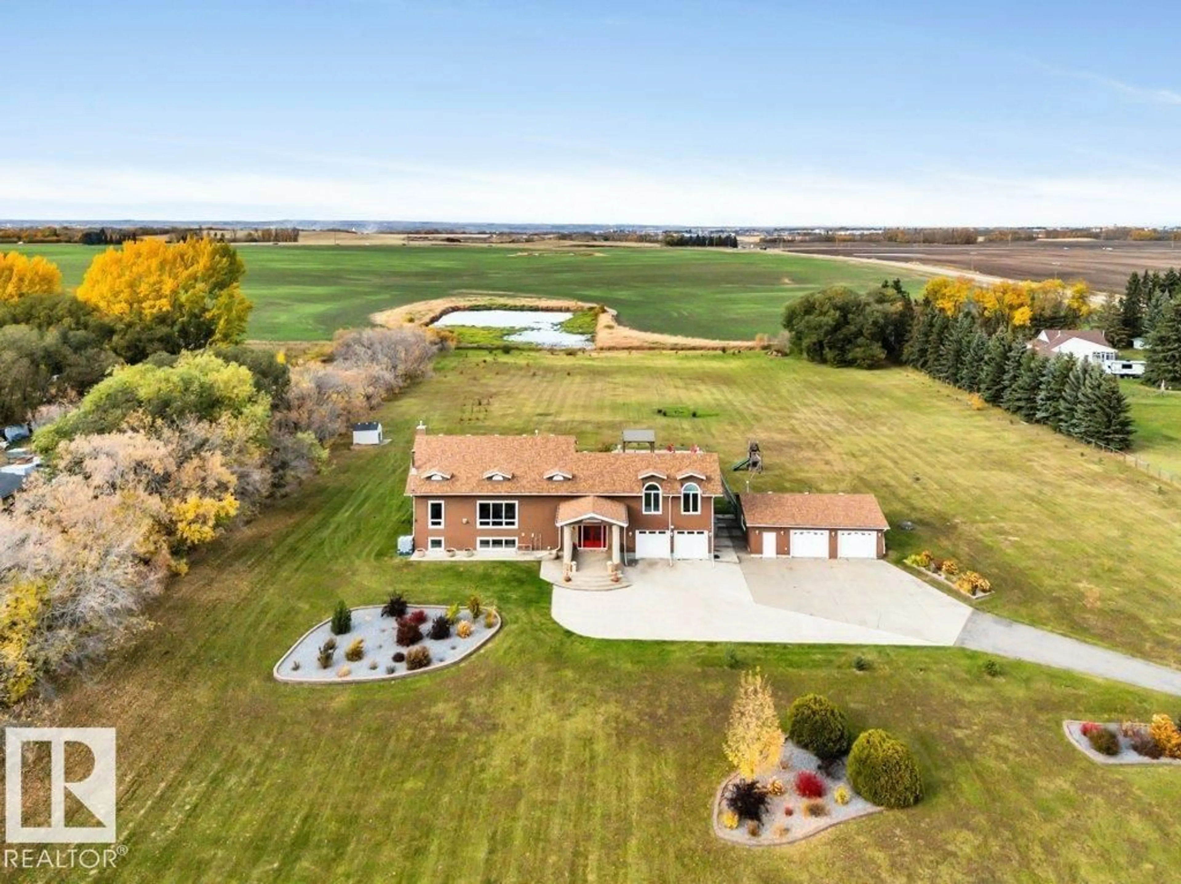 A pic from outside/outdoor area/front of a property/back of a property/a pic from drone, water/lake/river/ocean view for 4 - 52312 RGE RD 274, Rural Parkland County Alberta T7X3T7