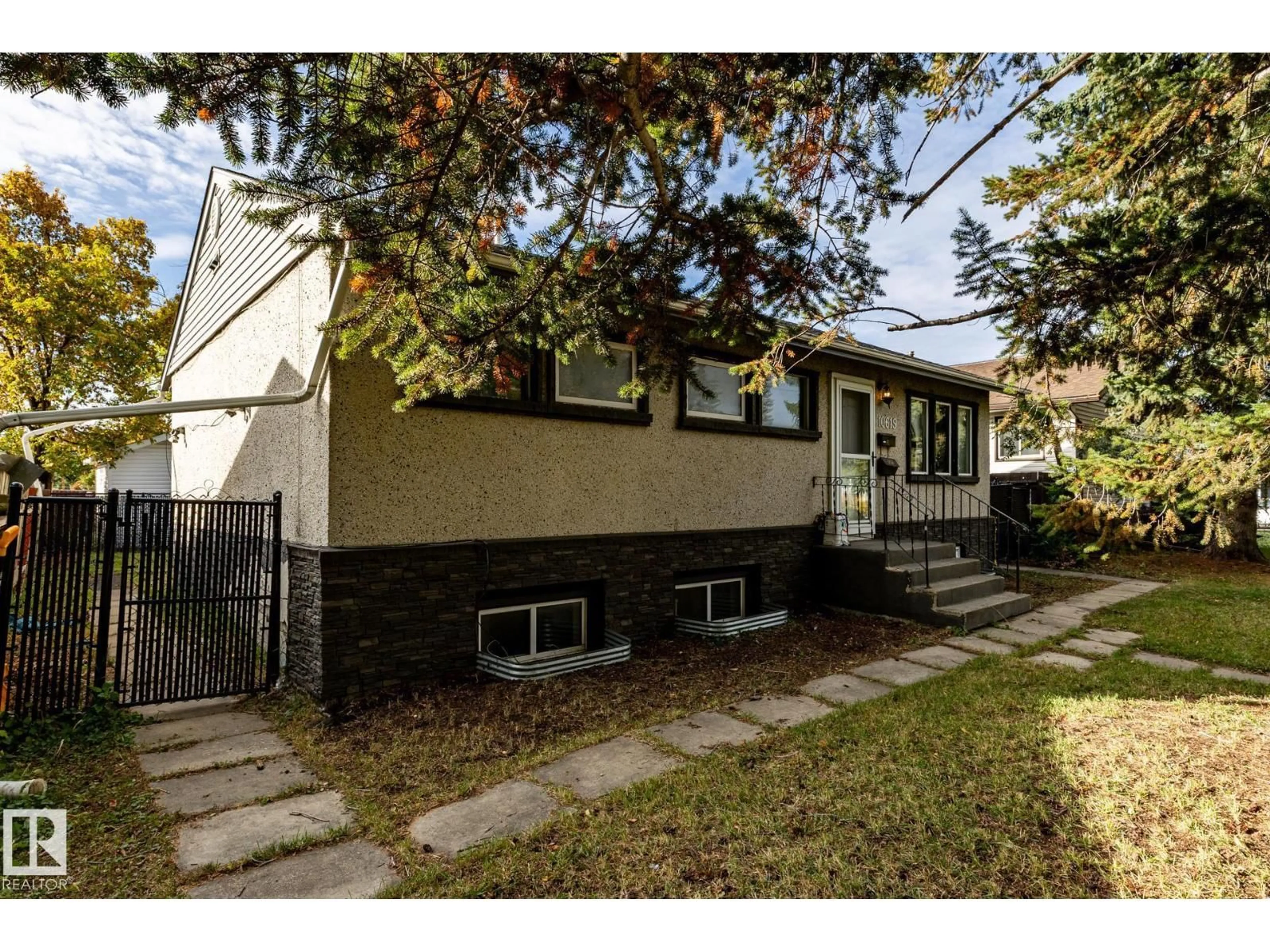 Home with vinyl exterior material, street for 10619 129 AV, Edmonton Alberta T5E0L3