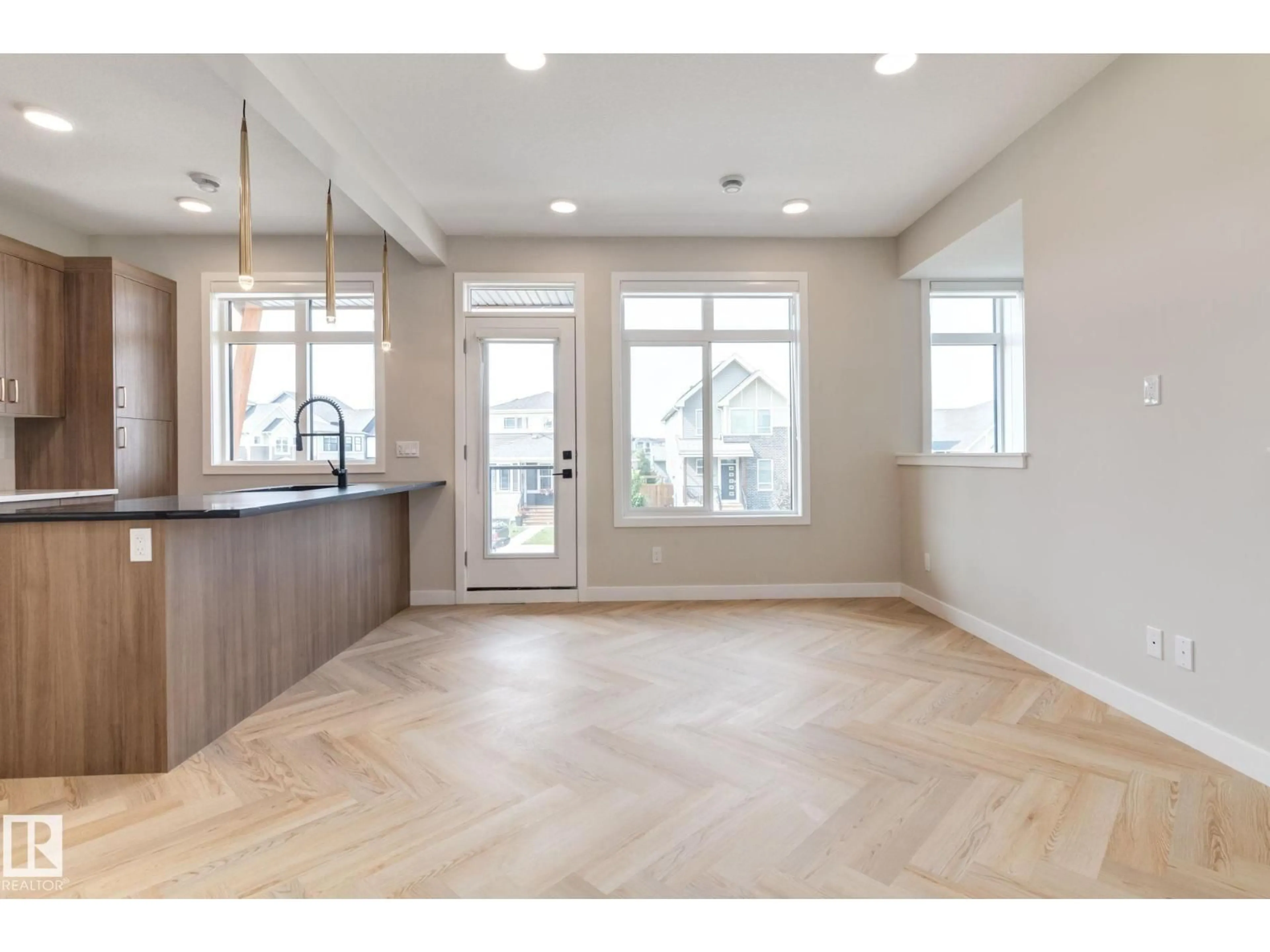 Open concept kitchen, wood/laminate floor for #11 - 16231 19 AV, Edmonton Alberta T6W5C6