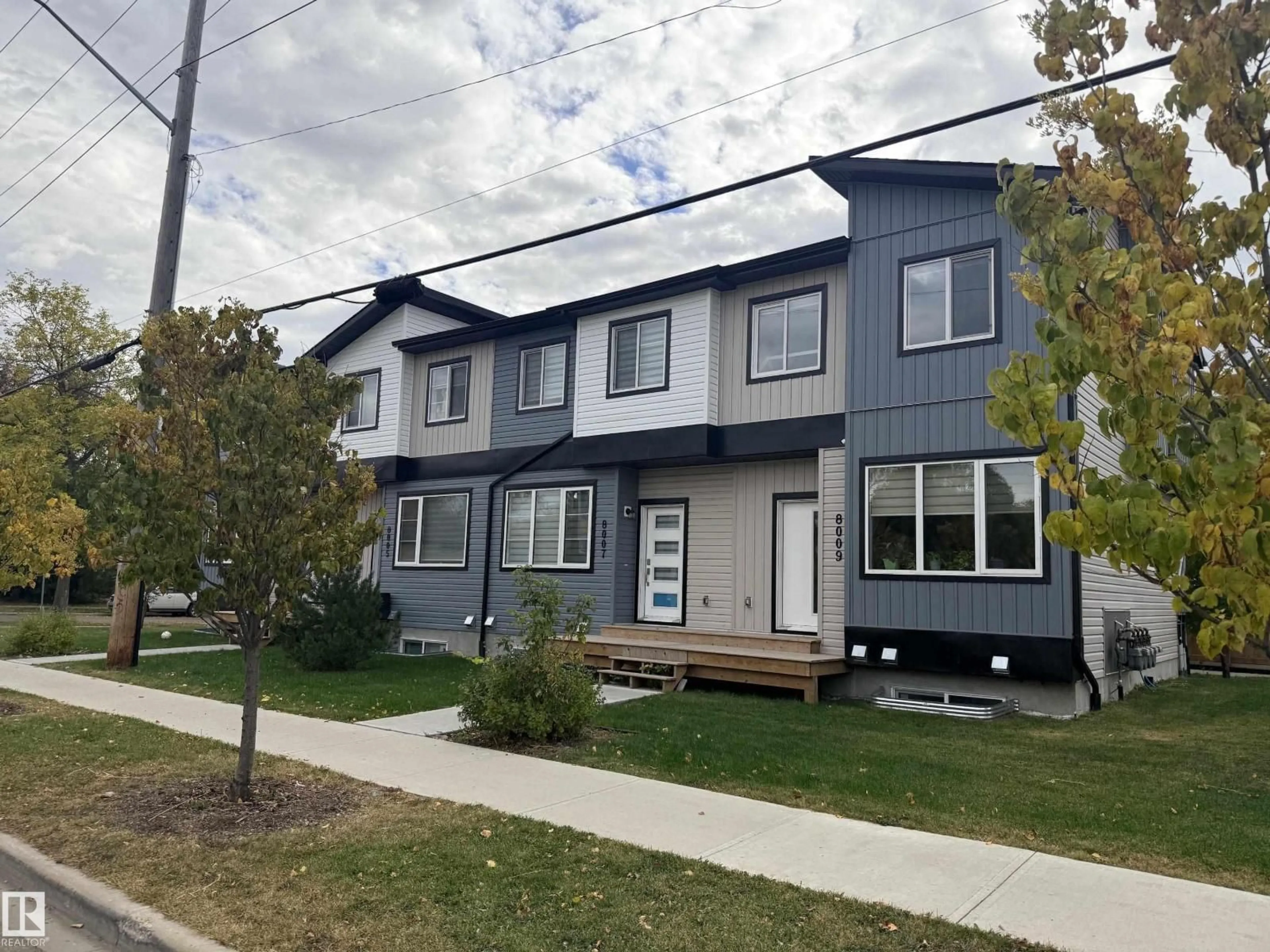 Home with vinyl exterior material, street for NW - 8009 120 AV, Edmonton Alberta T5B2N8